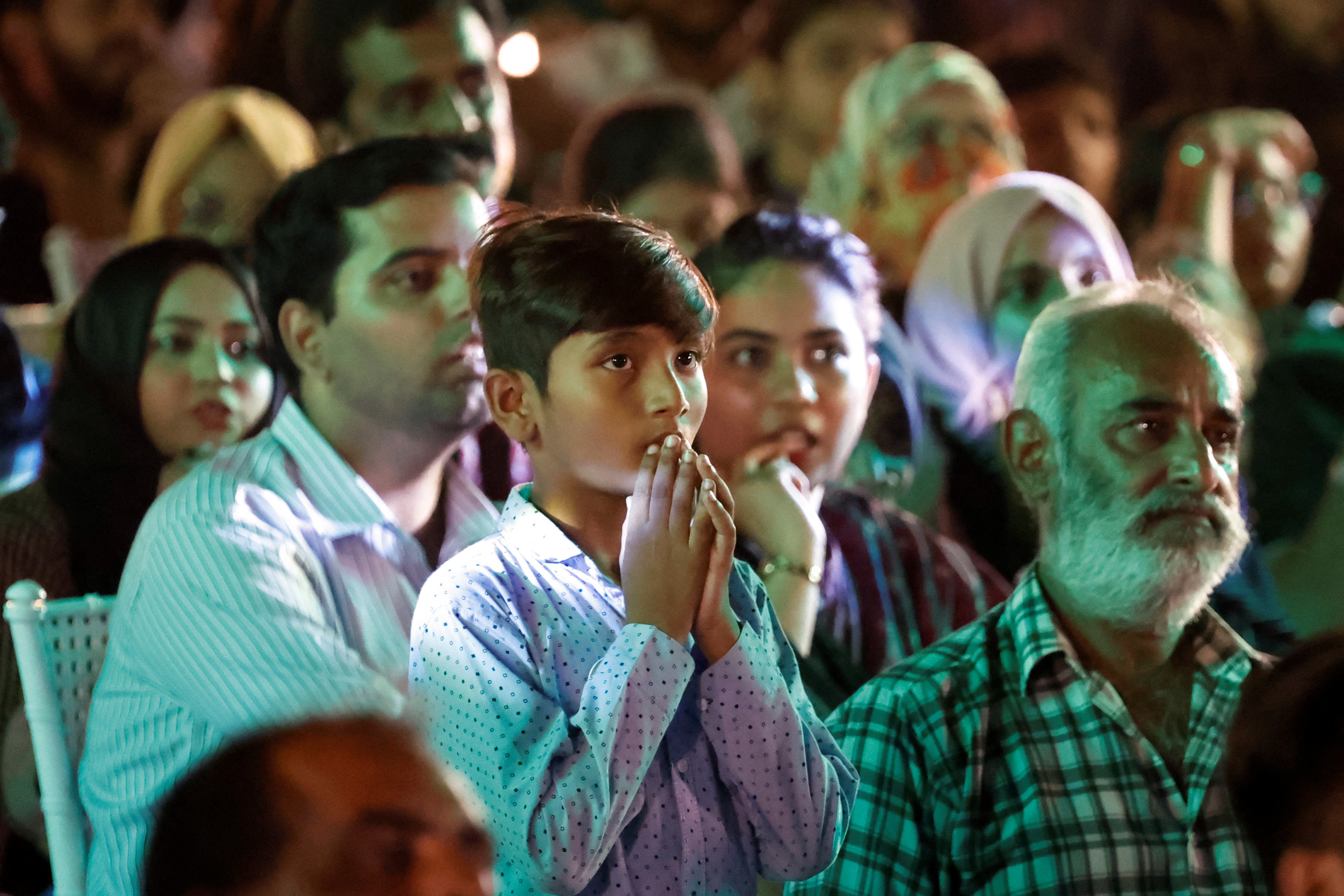 Pakistani cricket fans react as they watch the cricket match between India v Pakistan in the ICC T20 World Cup 2024 in New York, on a big screen in Karachi, Pakistan, June 10, 2024. REUTERS/Akhtar Soomro