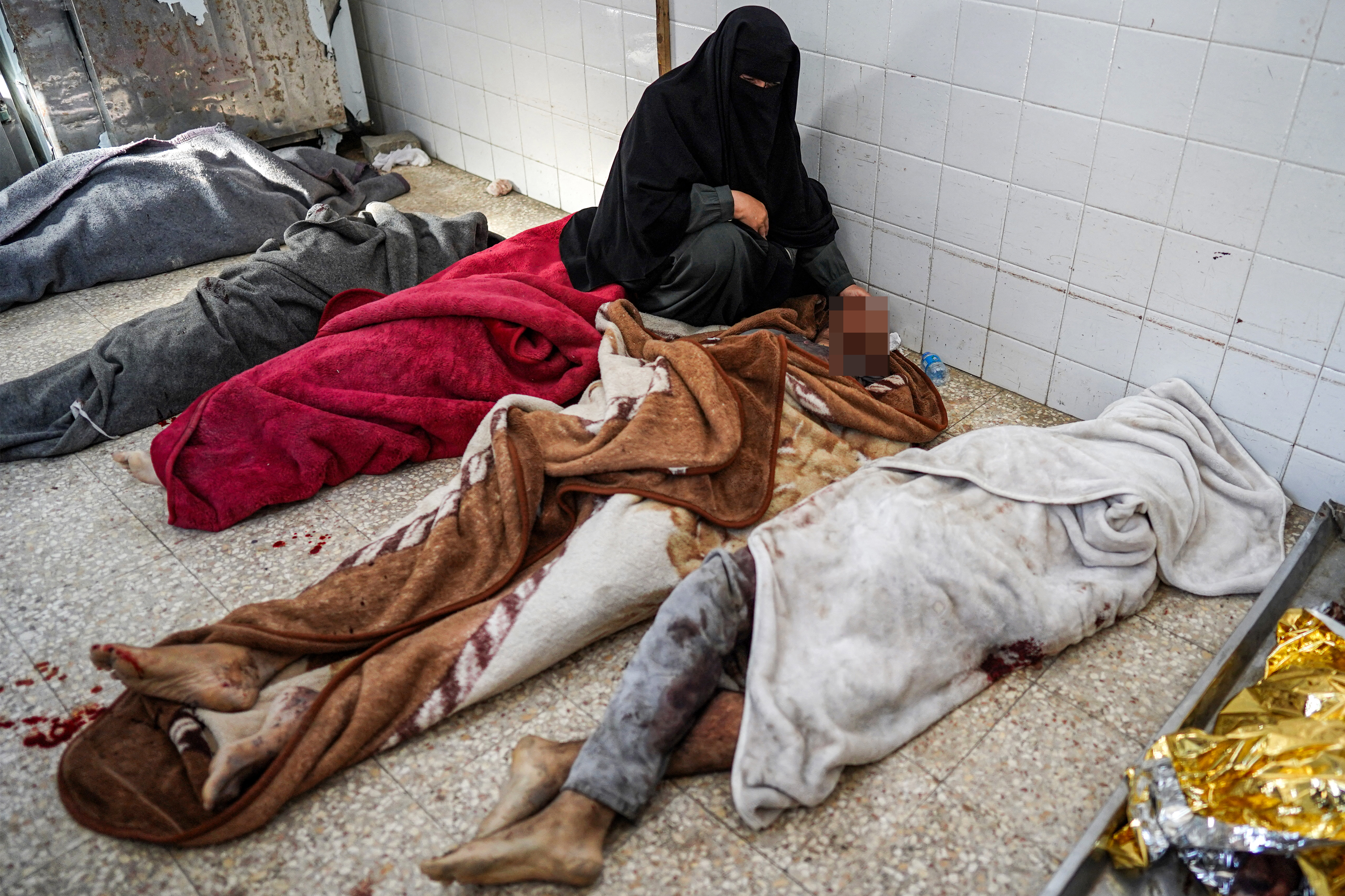 A woman reacts as she mourns by the body of her brother who was killed in the aftermath of overnight Israeli bombardment in al-Maghazi in the central Gaza Strip