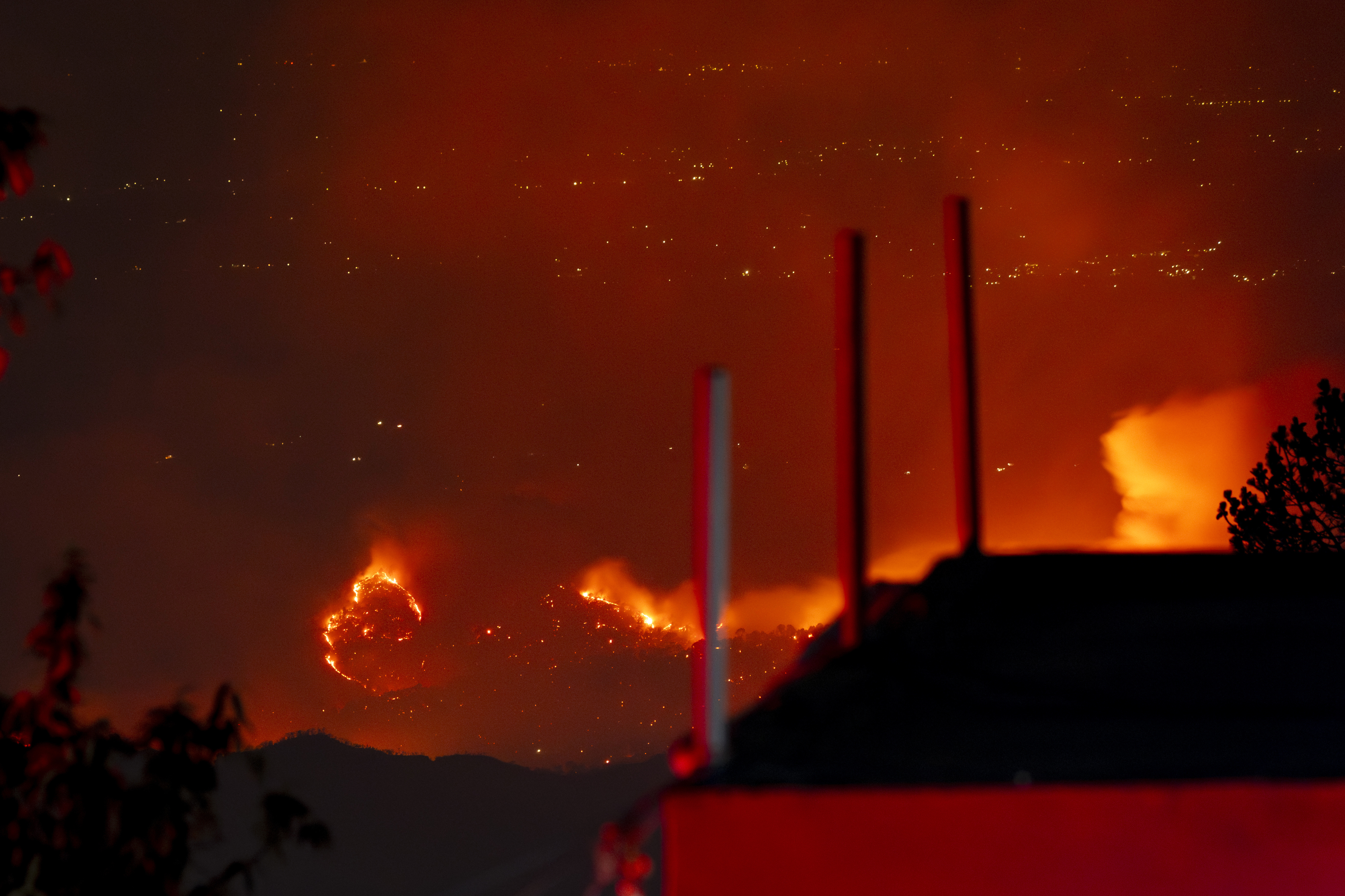 A fire burns in a distant forest in the Kangra valley in Dharamshala, India, Thursday, June 13, 2024. Fires are common in pine forests of the area during the hot dry months before the monsoon rains. (AP Photo/Ashwini Bhatia)