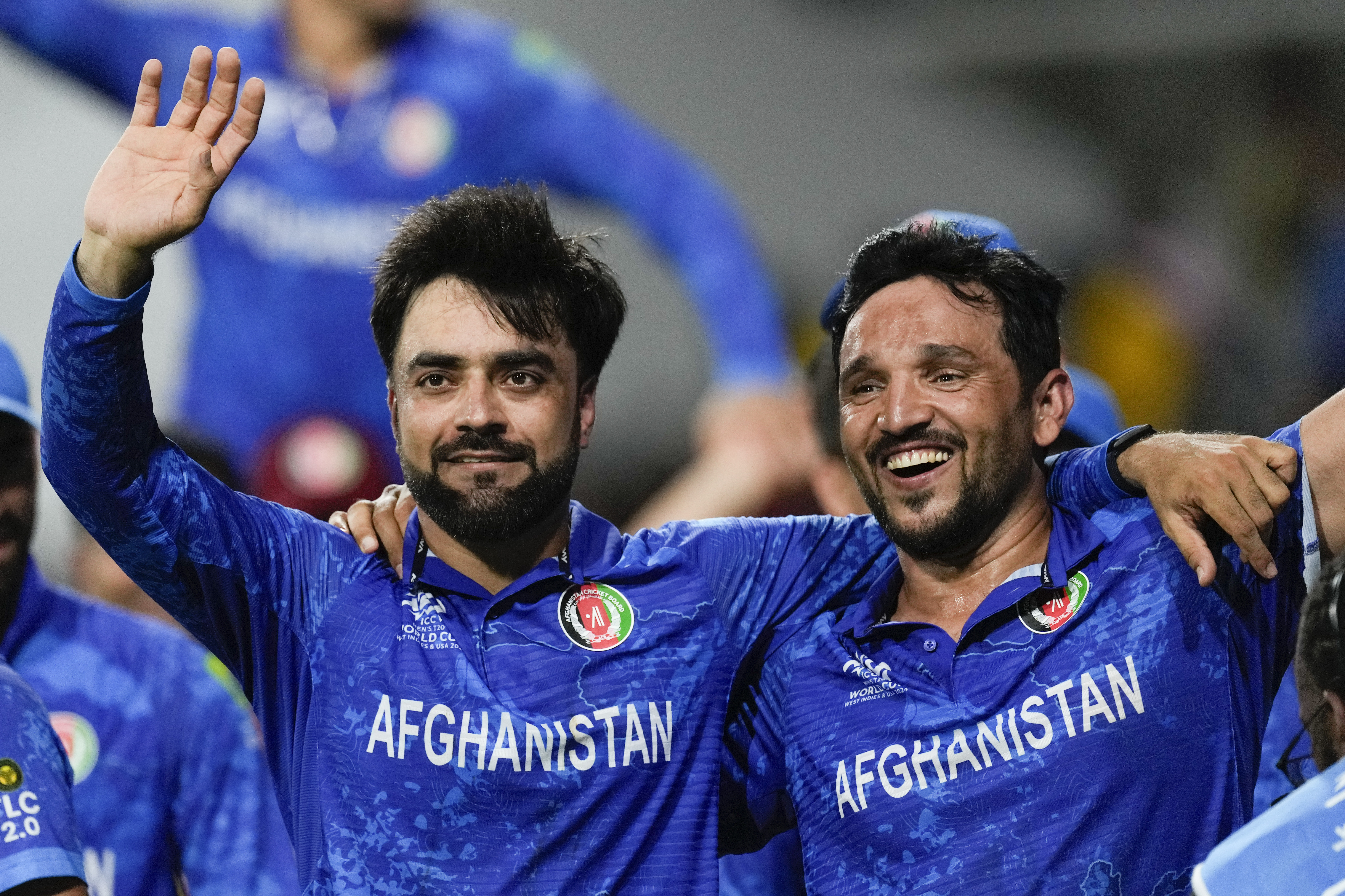 Afghanistan's captain Rashid Khan, left, and teammate Gulbadin Naib celebrate after defeating Bangladesh by eight runs in their men's T20 World Cup cricket match at Arnos Vale Ground, Kingstown, Saint Vincent and the Grenadines, Monday, June 24, 2024. (AP Photo/Ricardo Mazalan)