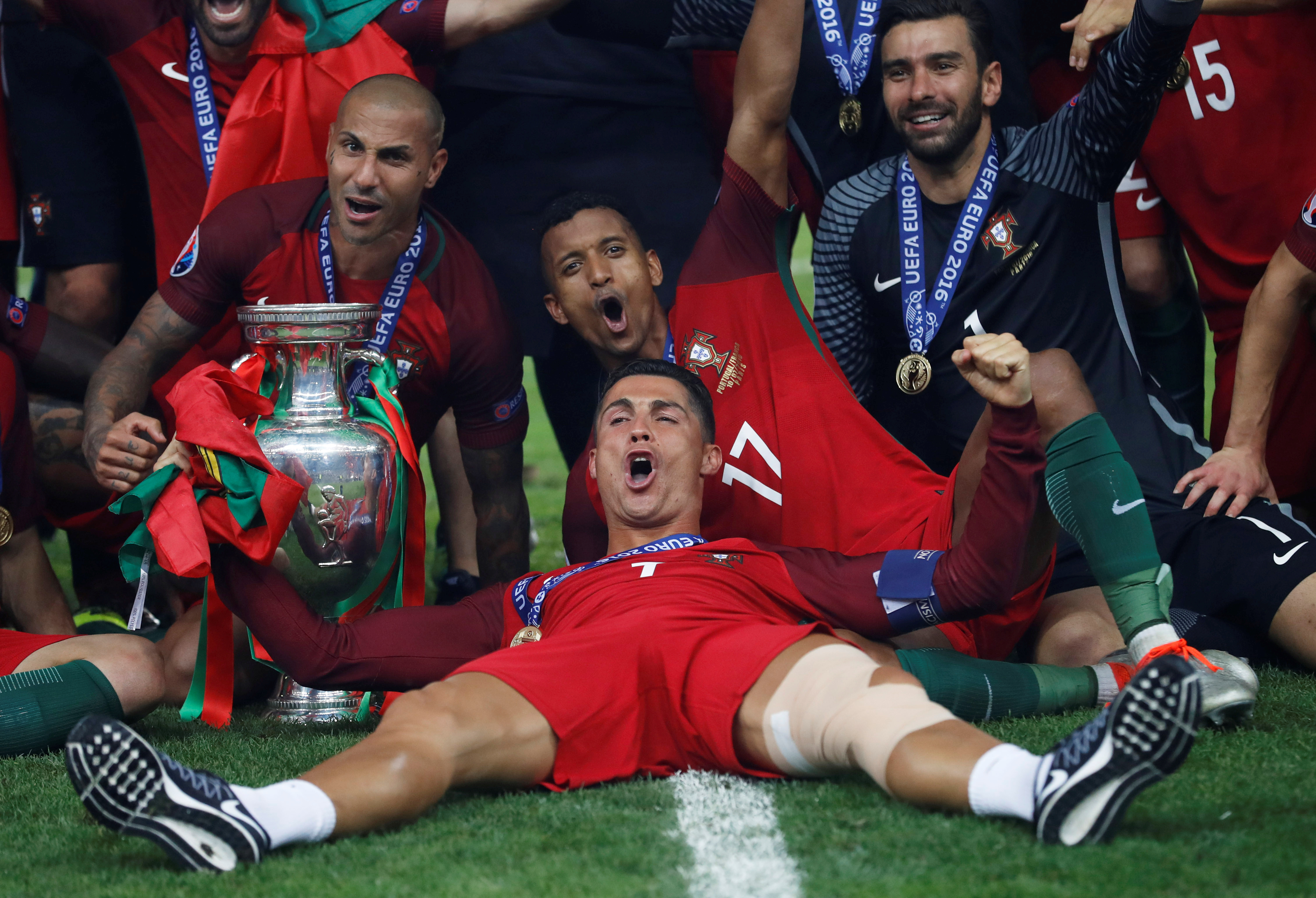 Football Soccer - Portugal v France - EURO 2016 - Final - Stade de France, Saint-Denis near Paris, France - 10/7/16Portugal's Cristiano Ronaldo celebrates with Ricardo Quaresma, Nani, Rui Patricio and the trophy after winning Euro 2016 REUTERS/Carl RecineLivepic TPX IMAGES OF THE DAY