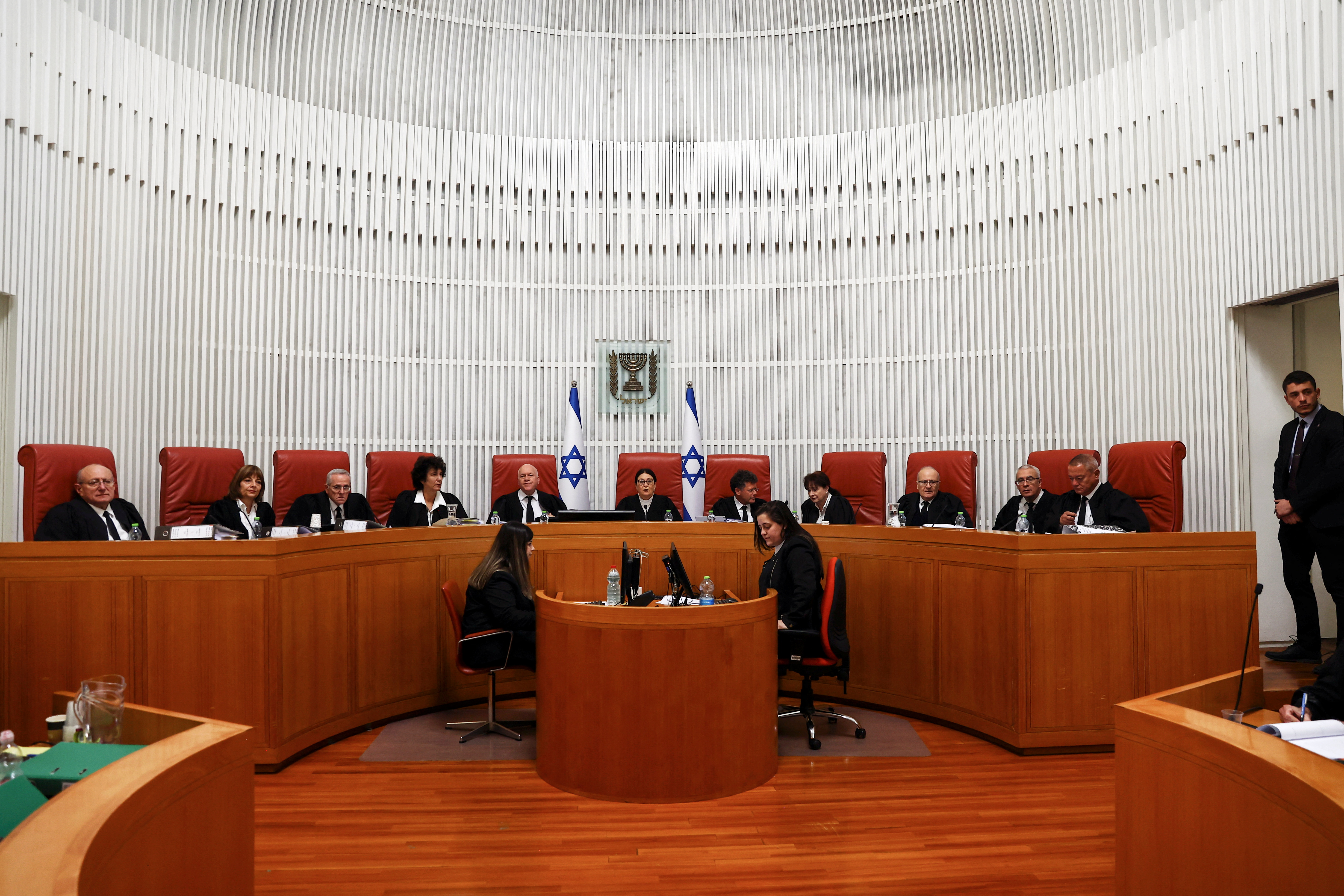 Chief Justice Esther Hayut and fellow Israeli Supreme Court judges attend a hearing on appeal against the appointment of Interior and Health Minister Aryeh Deri at the High Court in Jerusalem January 5, 2023 REUTERS/Ronen Zvulun