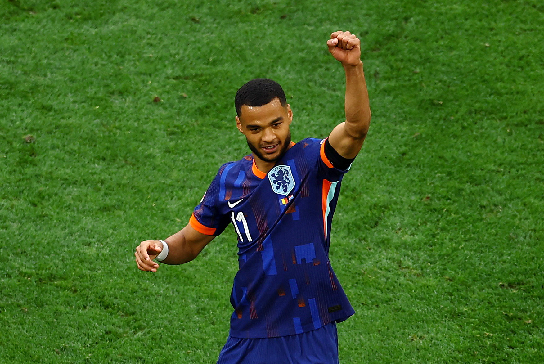 Footballer celebrates scoring goal.