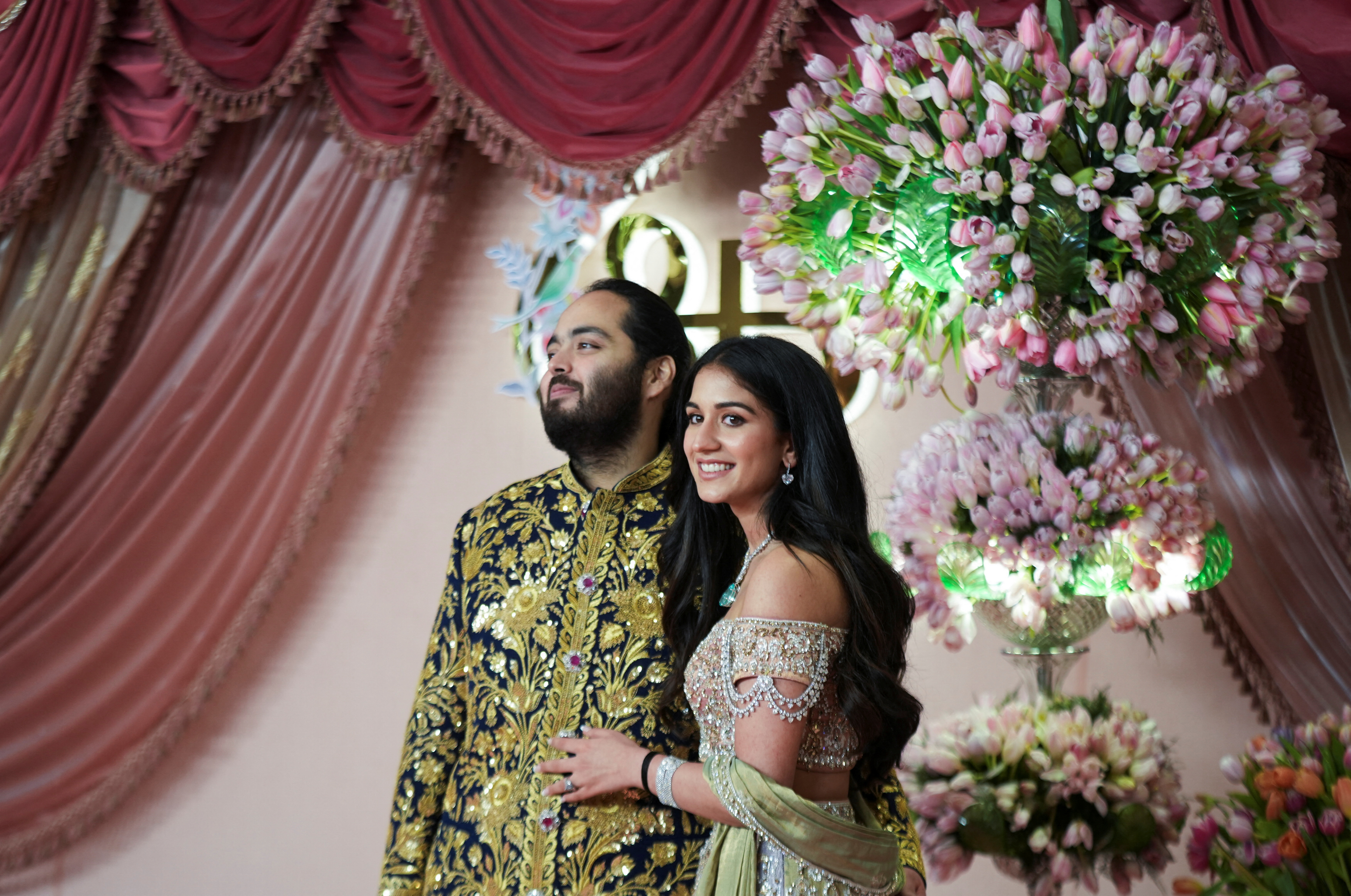 Anant Ambani, son of businessman Mukesh Ambani, poses with his fiance Radhika Merchant on the red carpet during the sangeet ceremony at Jio World Centre, Mumbai, India, July 5, 2024. REUTERS/Hemanshi Kamani (Reuters)