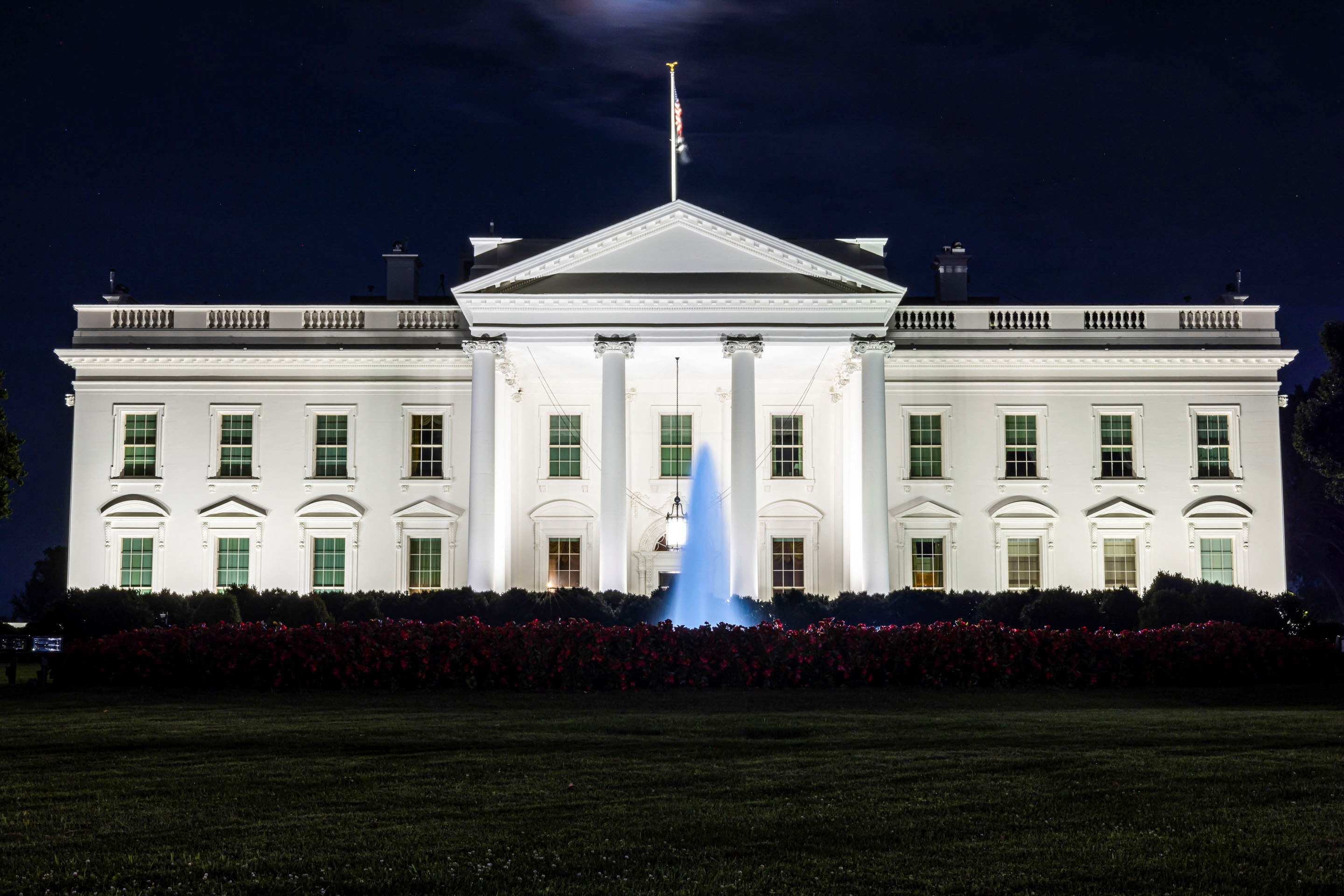 The White House exterior at night.