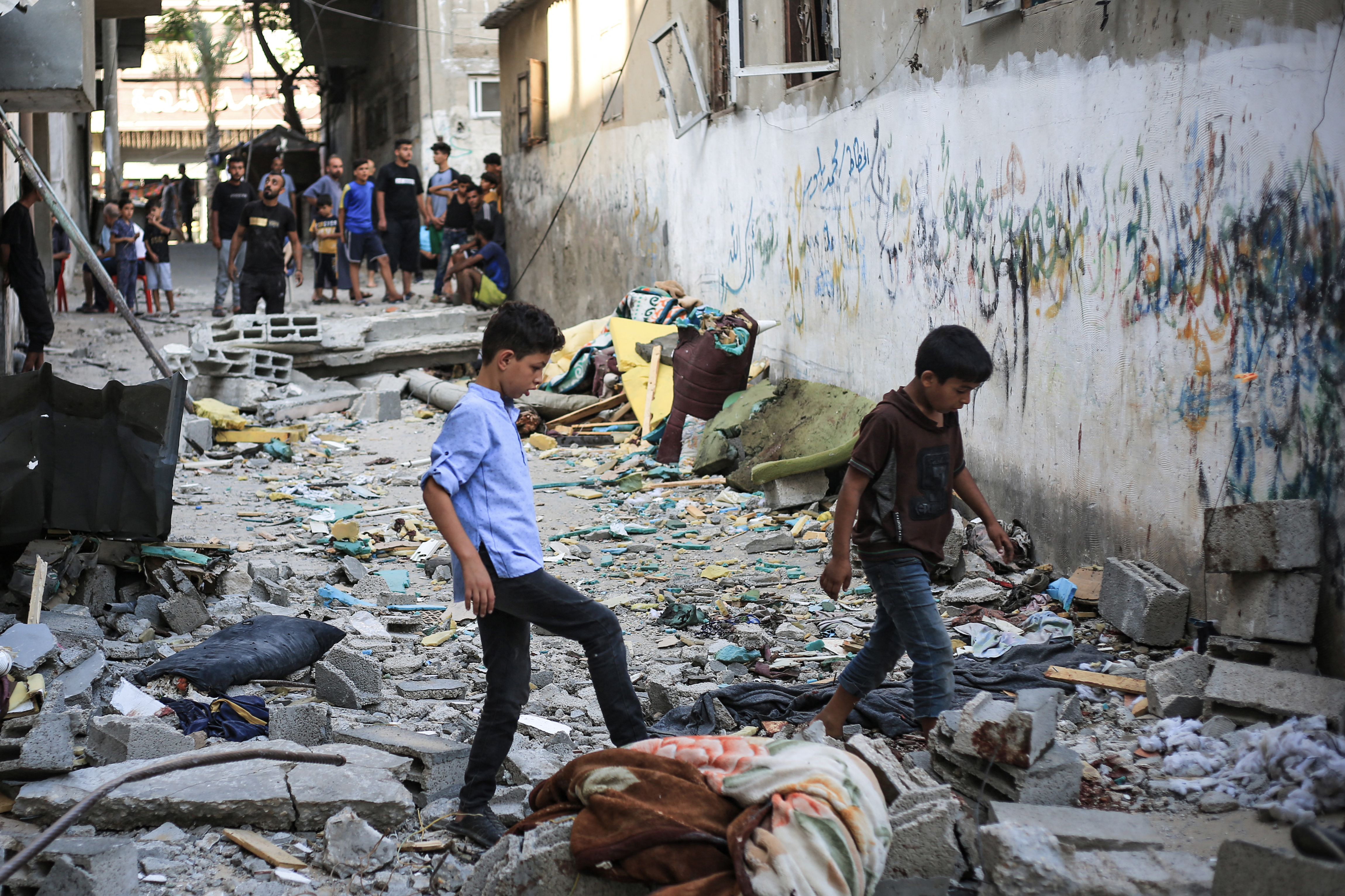 Palestinians asses the damage following an Israeli strike in the Nuseirat refugee camp in the central Gaza Strip on July 6, 2024. [Eyad Baba/AFP]