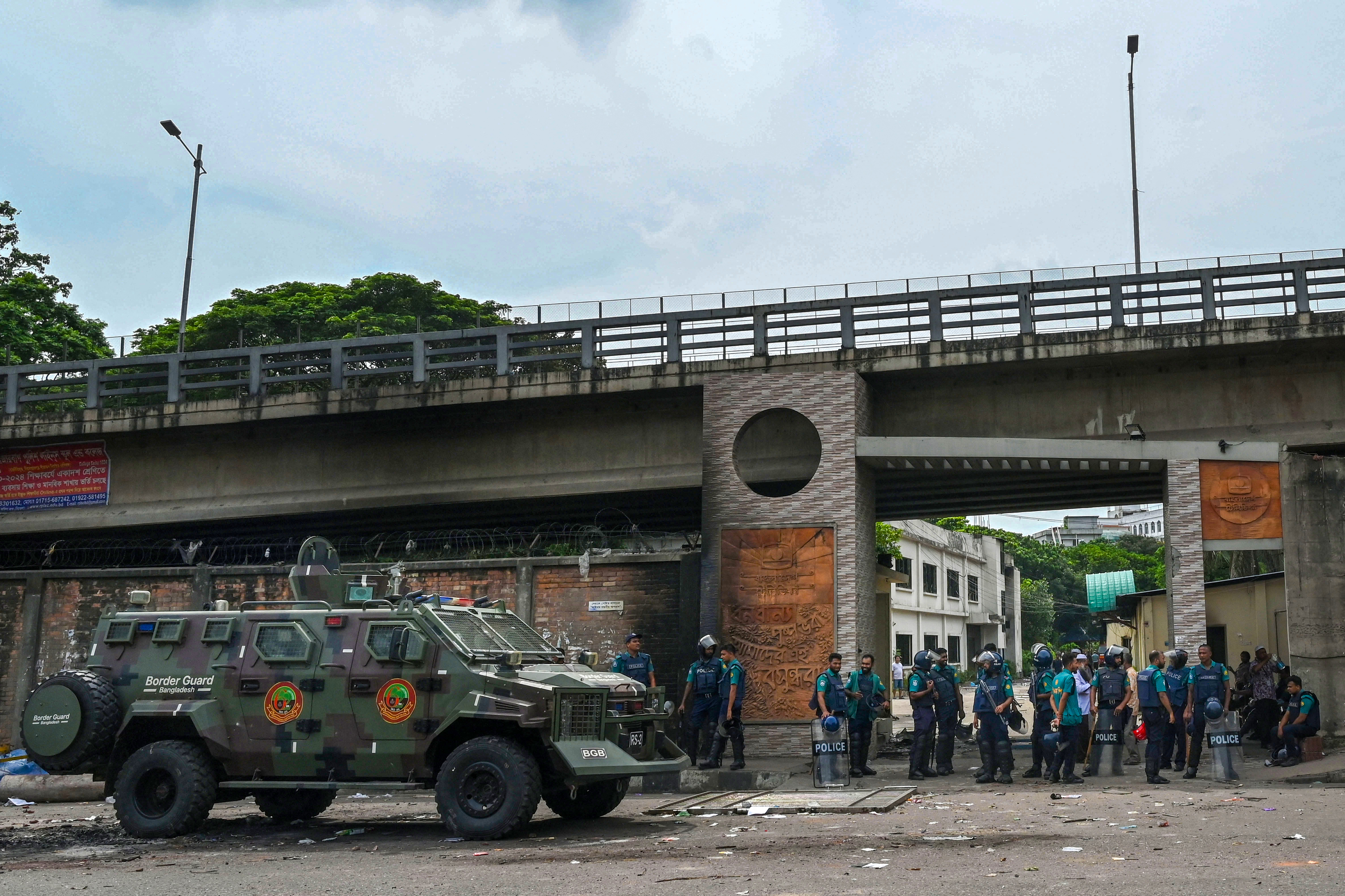 Police stand guard at the headquarters of state broadcaster Bangladesh Television