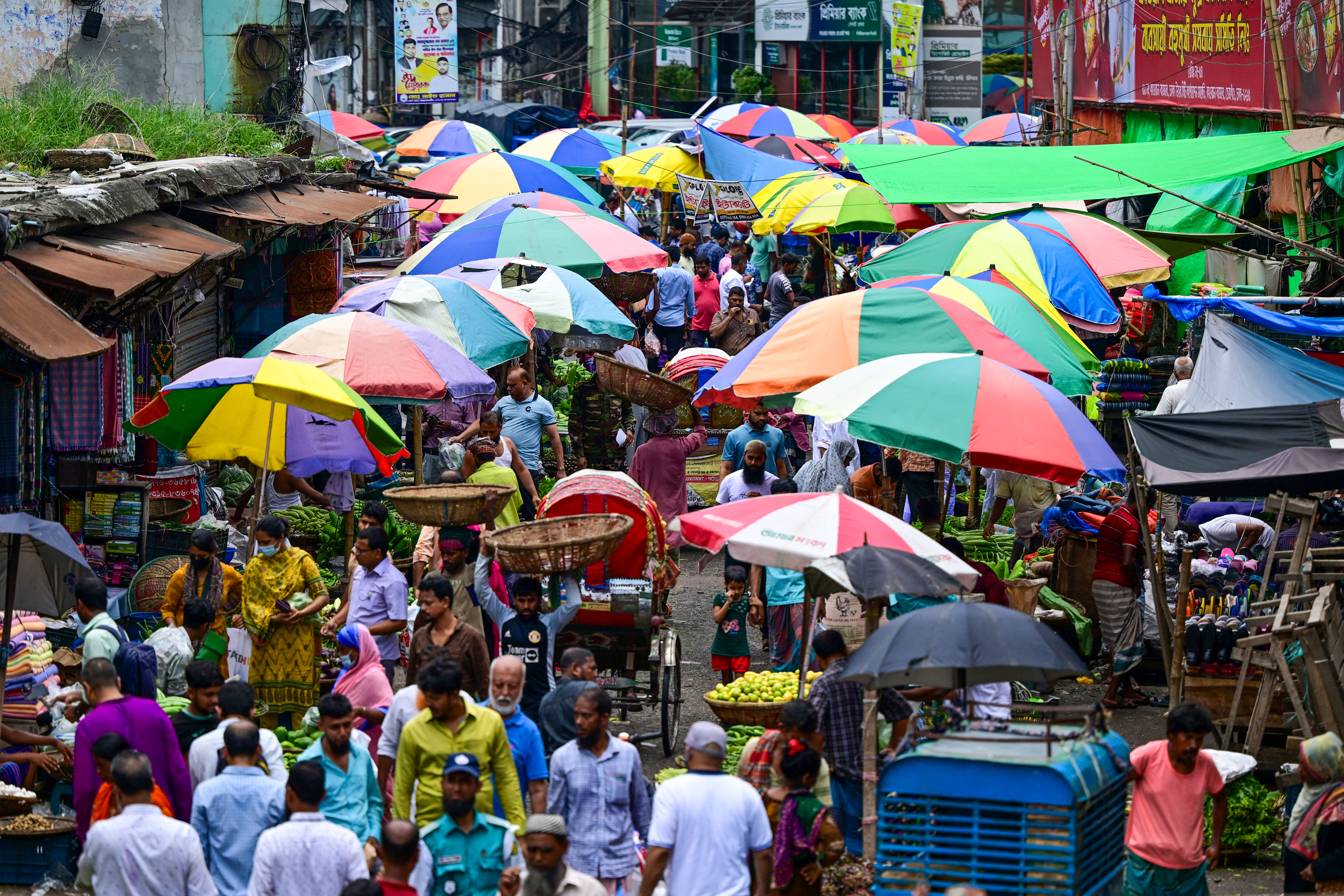 People shop at a market as the curfew is relaxed in Dhaka