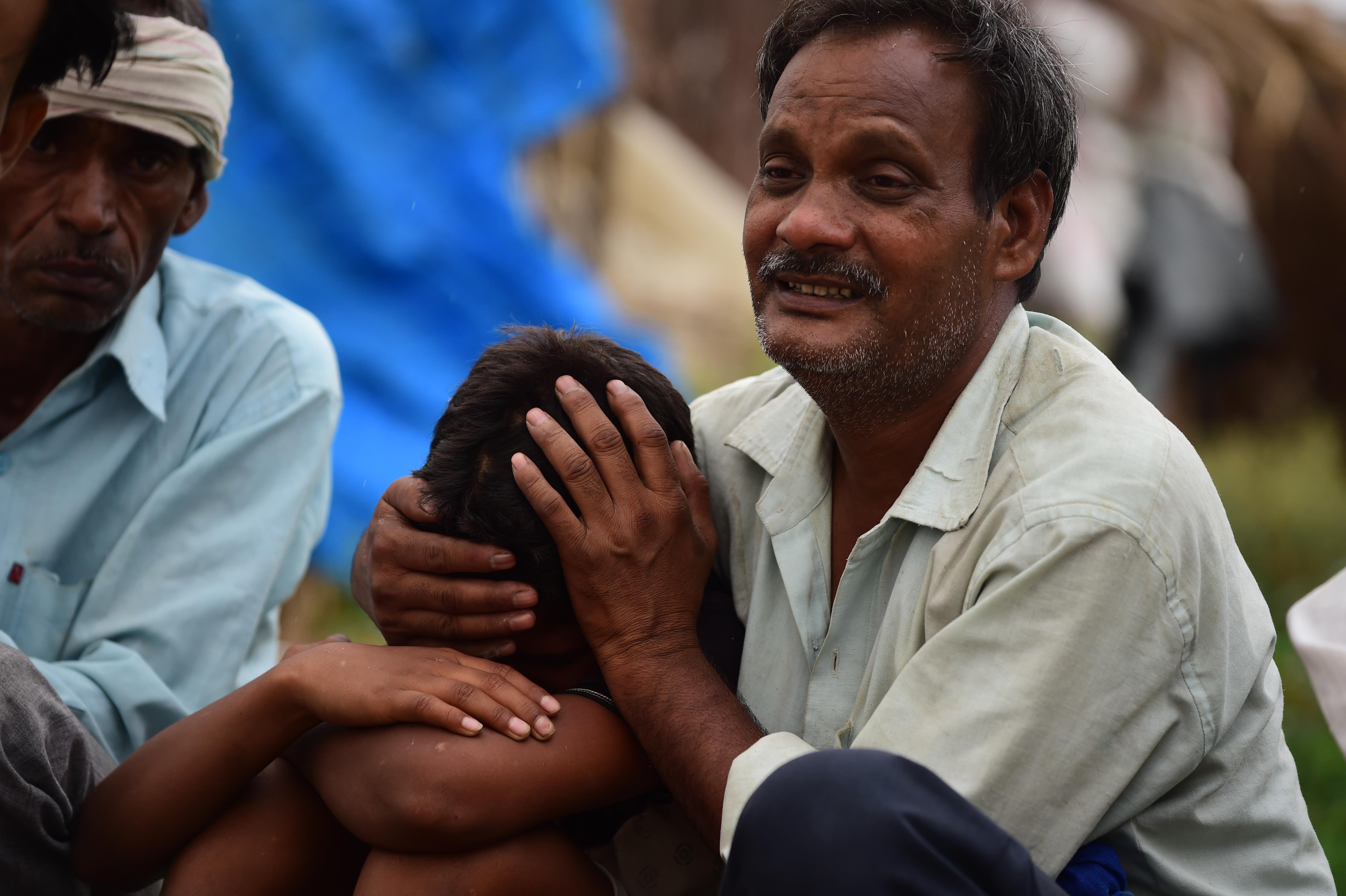 Vinod Kumar mourns during the cremation of his wife, mother, and daughter who died in the stampede in Hathras district, Uttar Pradesh