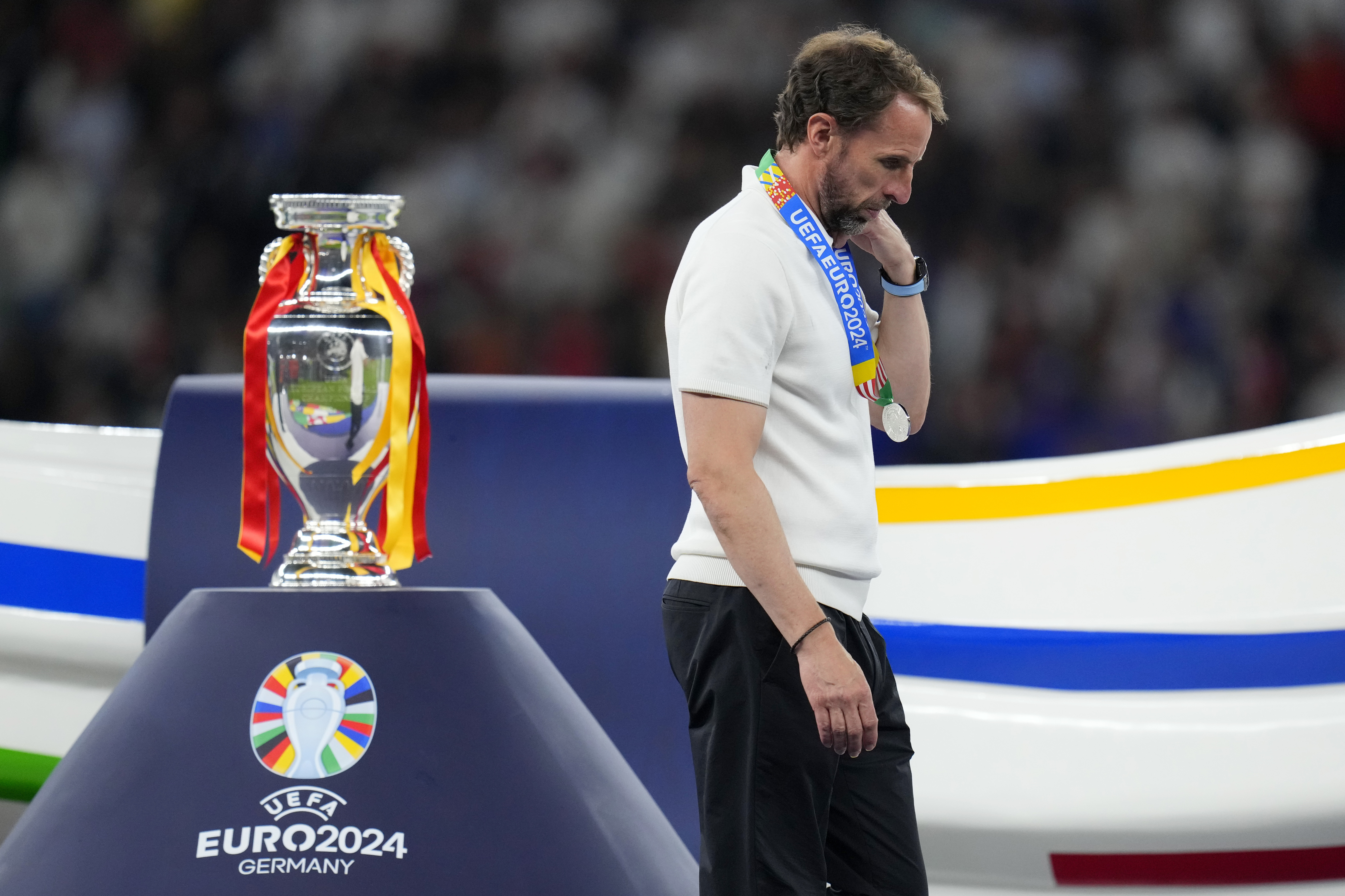 England's manager Gareth Southgate walks past the trophy at the end of the Euro 2024 final against Spain in Berlin