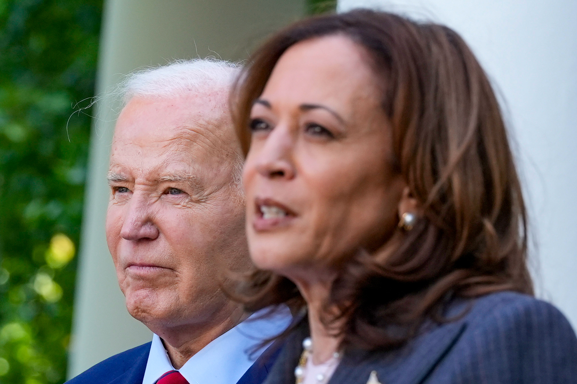 President Joe Biden listens as Vice President Kamala Harris speaks in the Rose Garden of the White House in Washington,