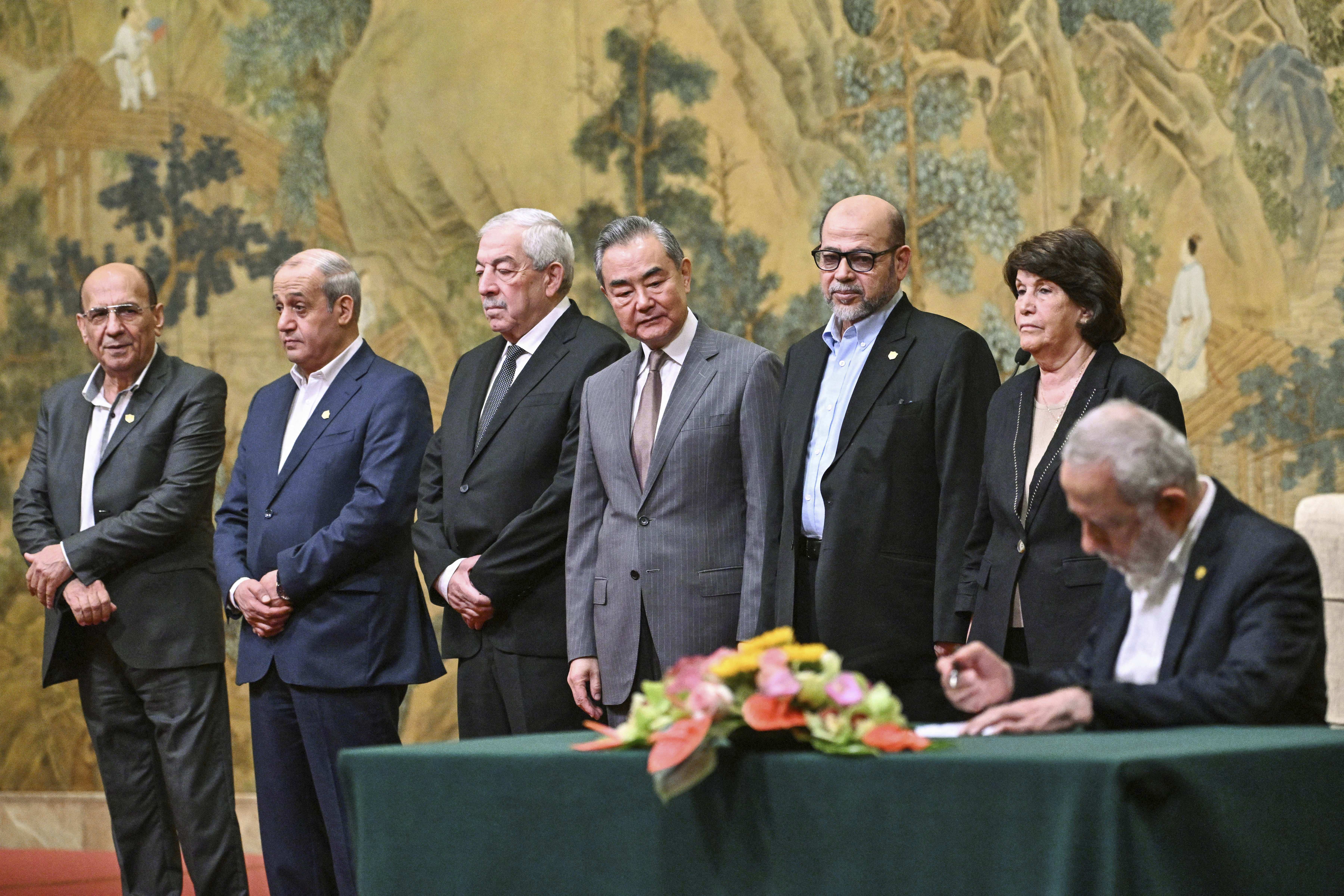 China's Foreign Minister Wang Yi, fourth left, looks on, while hosting an event of signing of the "Beijing declaration" between Palestinian factions, Fatah and Hamas, at the Diaoyutai State Guesthouse in Beijing, Tuesday, July 23, 2024. Mahmoud al-Aloul of Fatah, third left, and Mussa Abu Marzuk of Hamas, third right, are seen. [Pedro Pardo/AP]