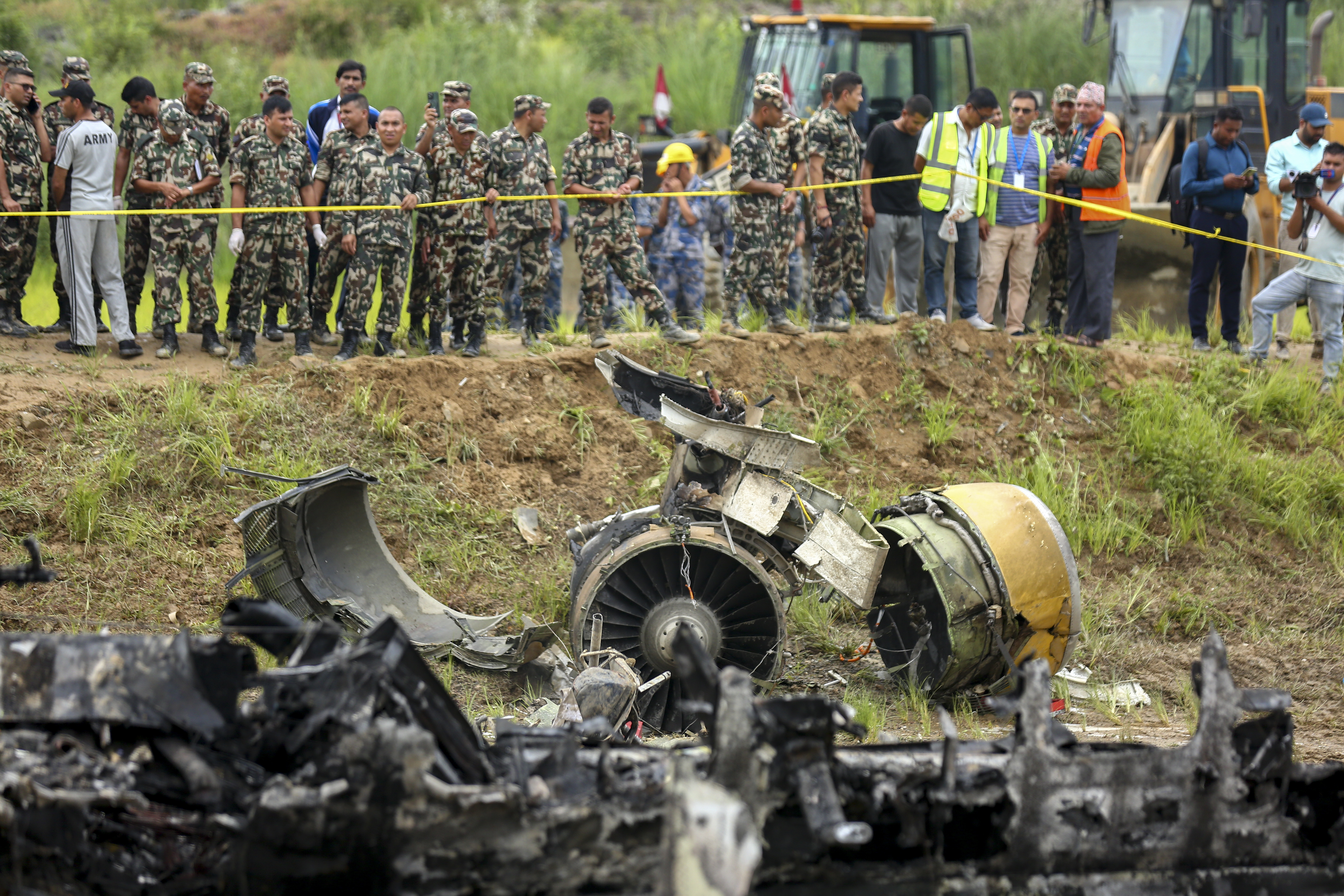 Nepal army personnel stand by a plane crash site at Tribhuvan International Airport in Kathmandu