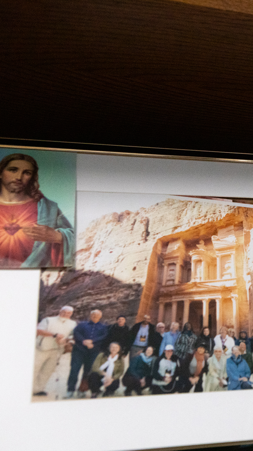 A framed photo of a church group in Jordan, with a Jesus picture pinned to one corner.