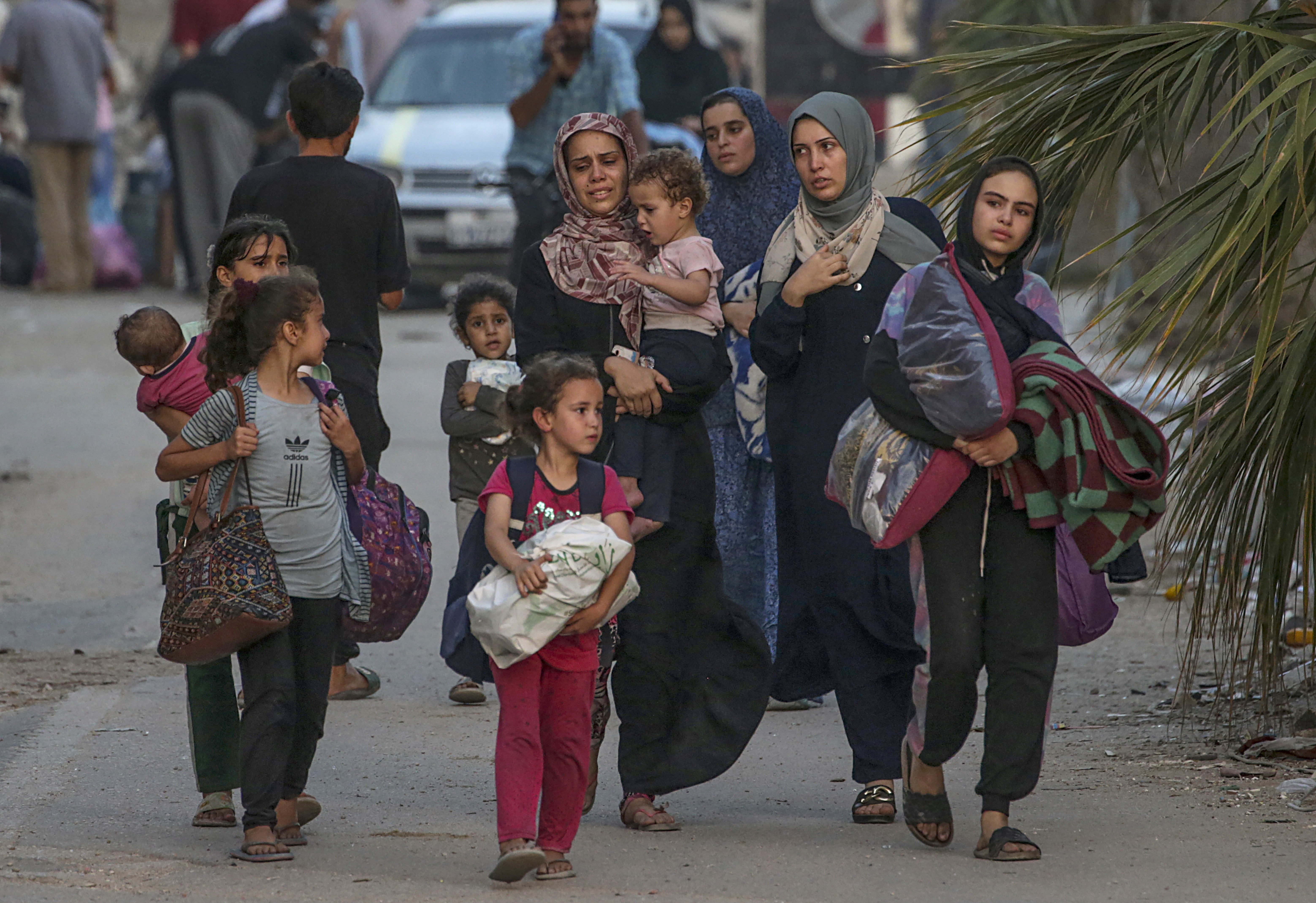 epa11390527 Internally displaced Palestinians, including women and children, leave with their belongings following an Israeli military operation in Al Bureij refugee camp, central Gaza Strip, 04 June 2024 (issued 05 June 2024). More than 36,000 Palestinians and over 1,400 Israelis have been killed, according to the Palestinian Health Ministry and the Israel Defense Forces (IDF), since Hamas militants launched an attack against Israel from the Gaza Strip on 07 October 2023, and the Israeli operations in Gaza and the West Bank which followed it. EPA-EFE/MOHAMMED SABER