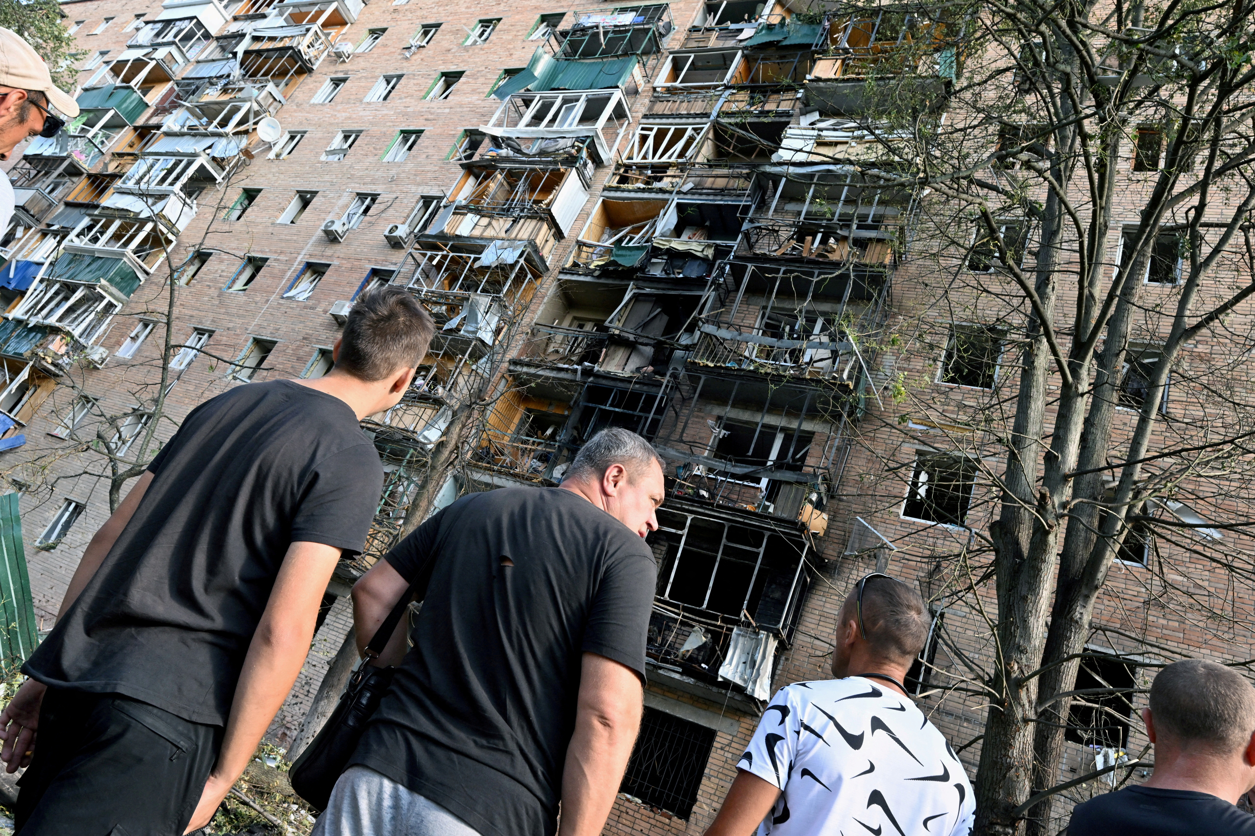 FILE PHOTO: People gather in the courtyard of a multi-storey residential building, which according to local authorities was hit by debris from a destroyed Ukrainian missile, in the course of Russia-Ukraine conflict in Kursk, Russia August 11, 2024. Kommersant Photo/Anatoliy Zhdanov via REUTERS RUSSIA OUT. NO COMMERCIAL OR EDITORIAL SALES IN RUSSIA./File Photo