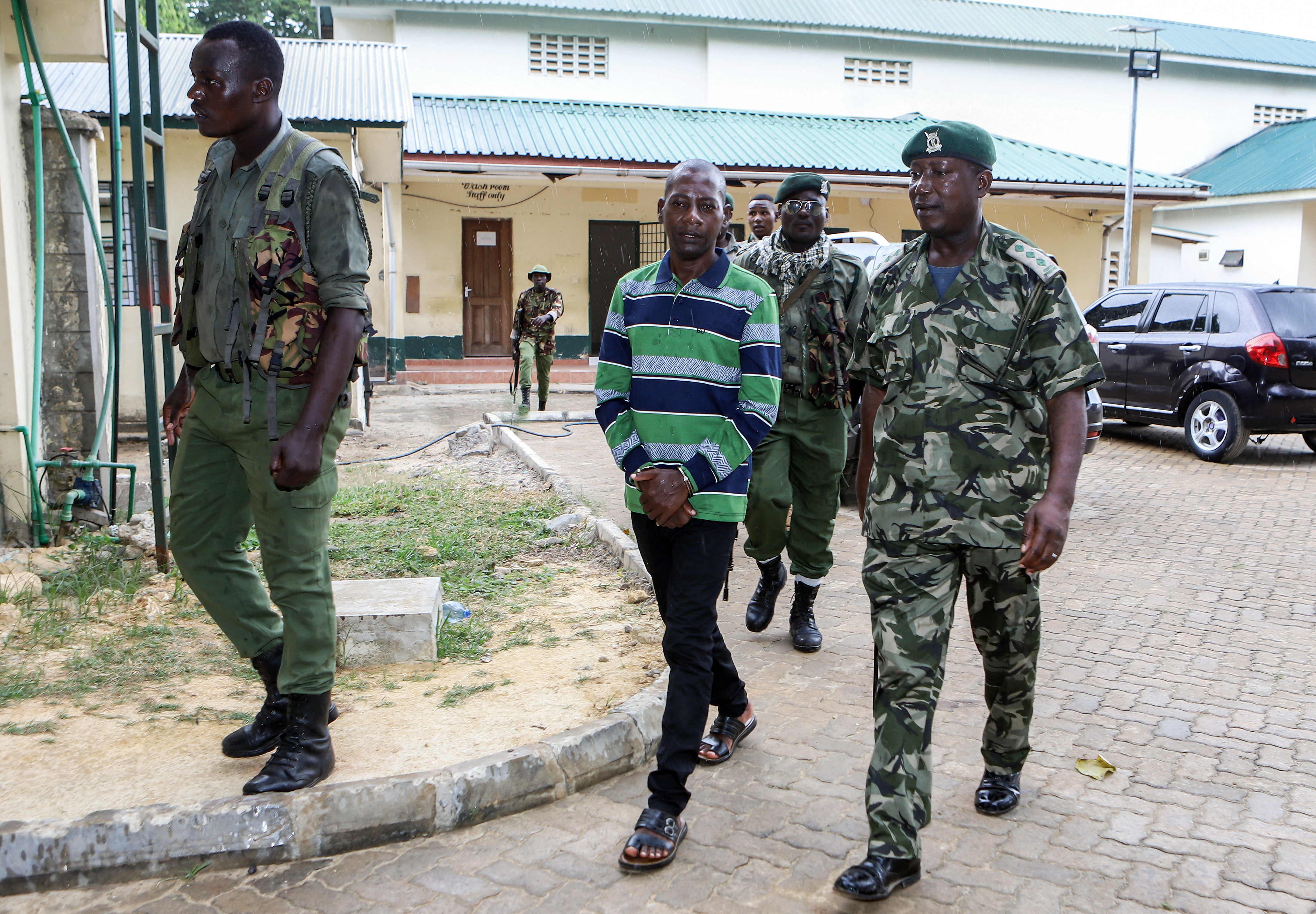 Self-proclaimed pastor Paul Mackenzie (C) walks surrounded by police officers as he appears at the Shanzu Law Courts in Mombasa, Kenya on January 18, 2024.