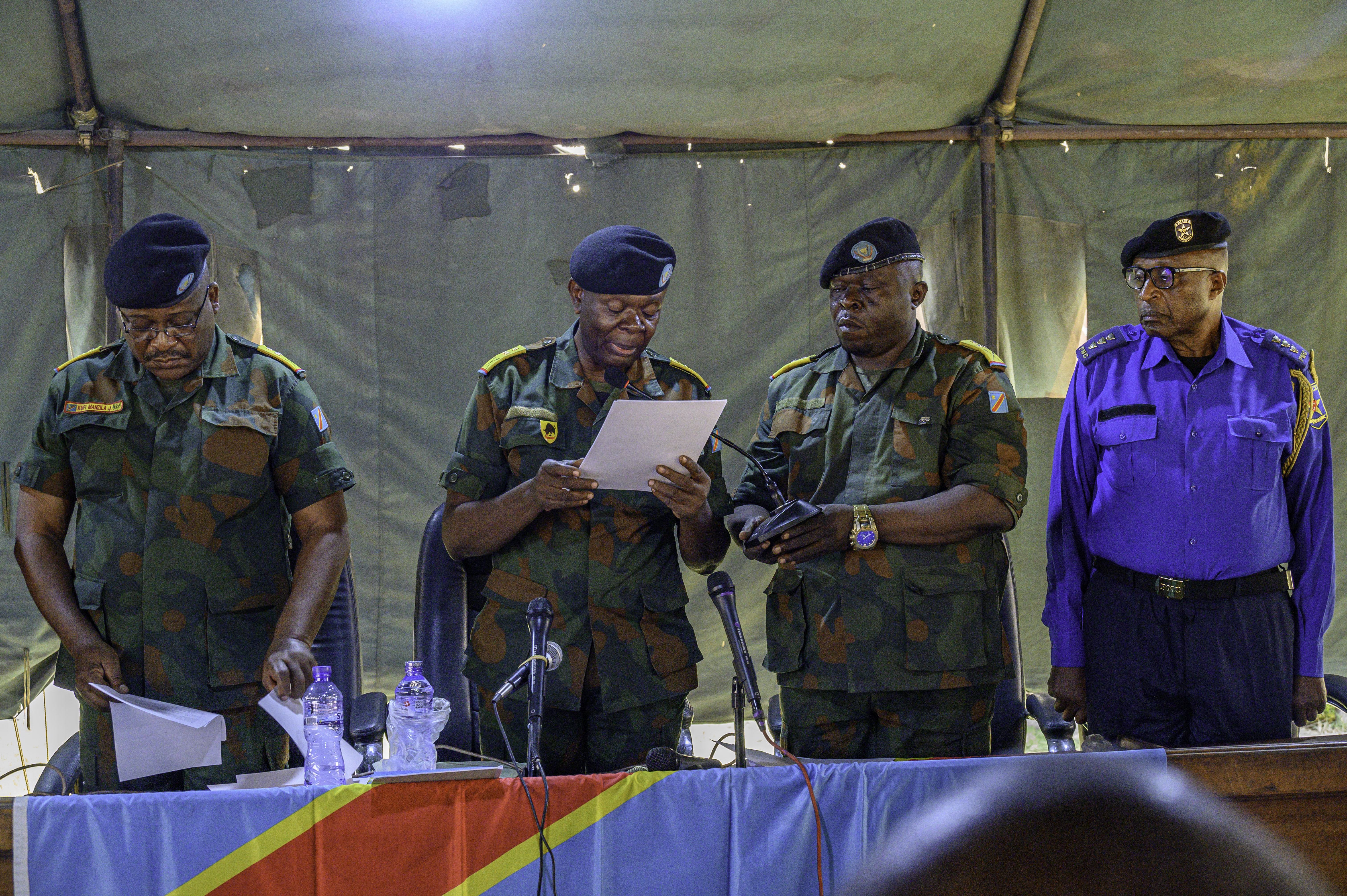 Colonel Robert Efomi (C), the presiding juge of the mitary court, reads the verdict to the defendants