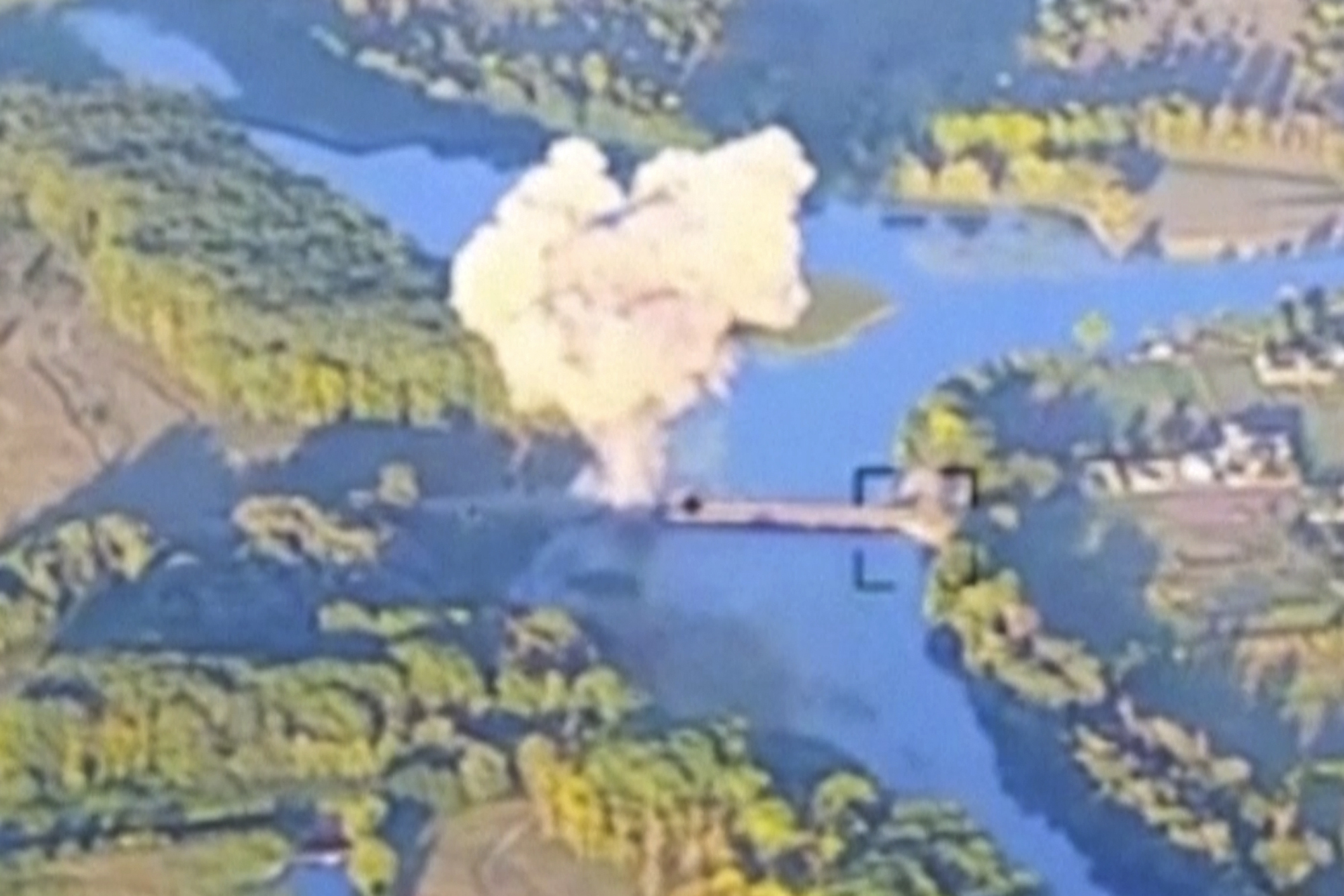 An aerial photo showing a cloud of white smoke rising into the air from the Kursk region. The plume is rising from a bridge across a river.