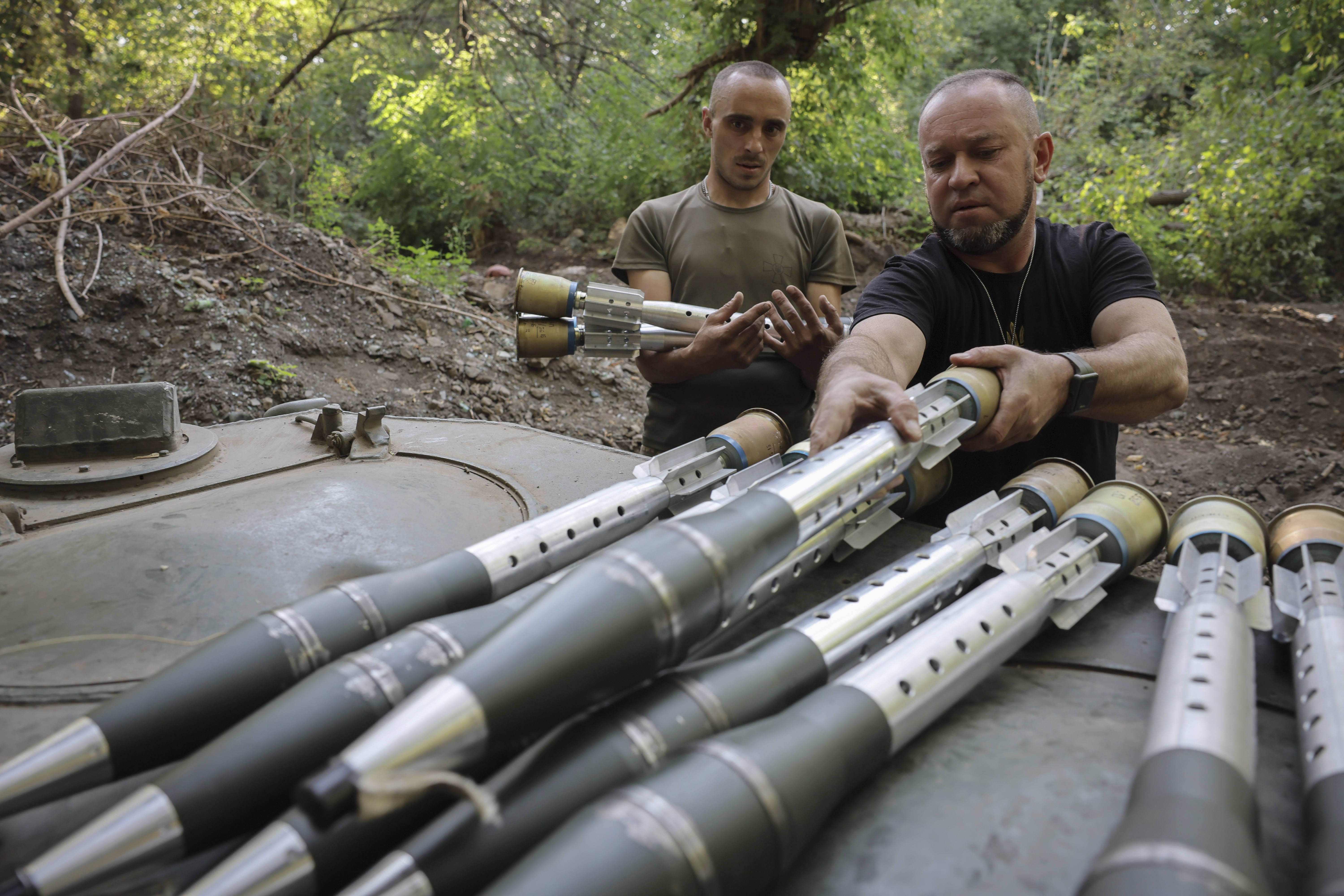 In this photo provided by Ukraine's 24th Mechanised Brigade press service, servicemen of 24th mechanised brigade prepare to fire BRM1k infantry fighting vehicle towards Russian positions near Chasiv Yar town, in Donetsk region, Ukraine, Saturday Aug. 17, 2024.