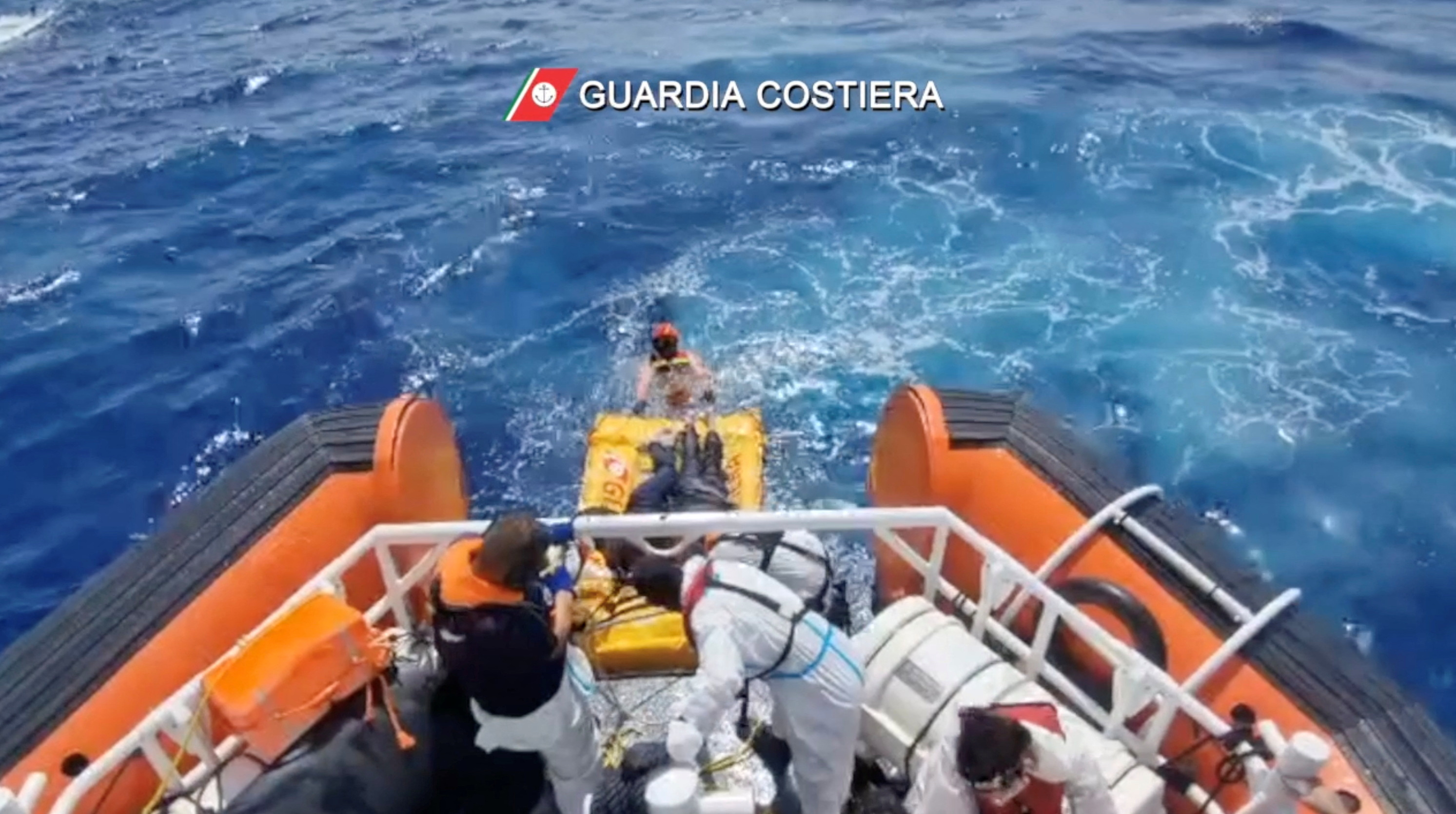Coast guard members rescue the seven survivors of a boat that had set off from Libya a few days ago