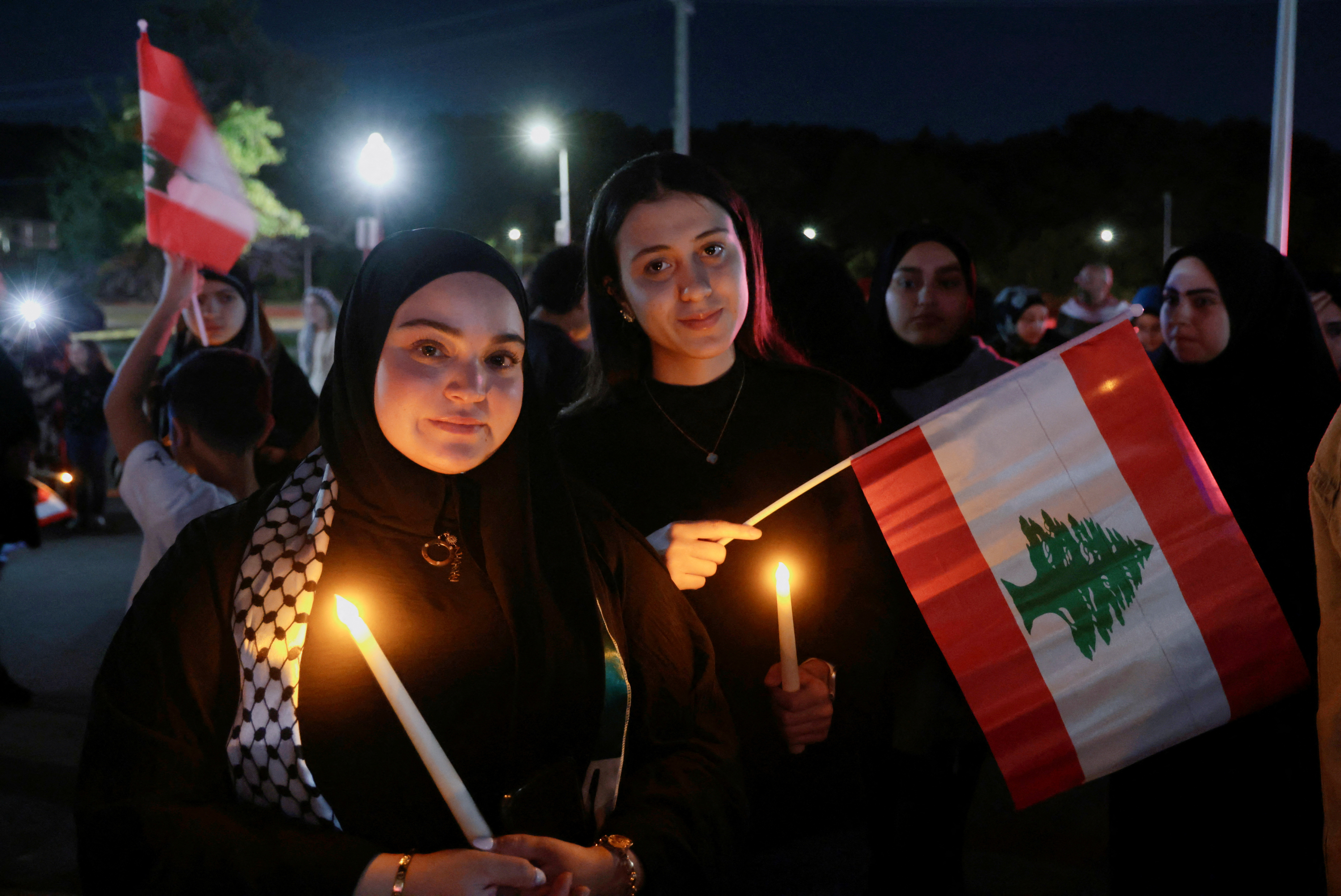 Young women wave Lebanese flags