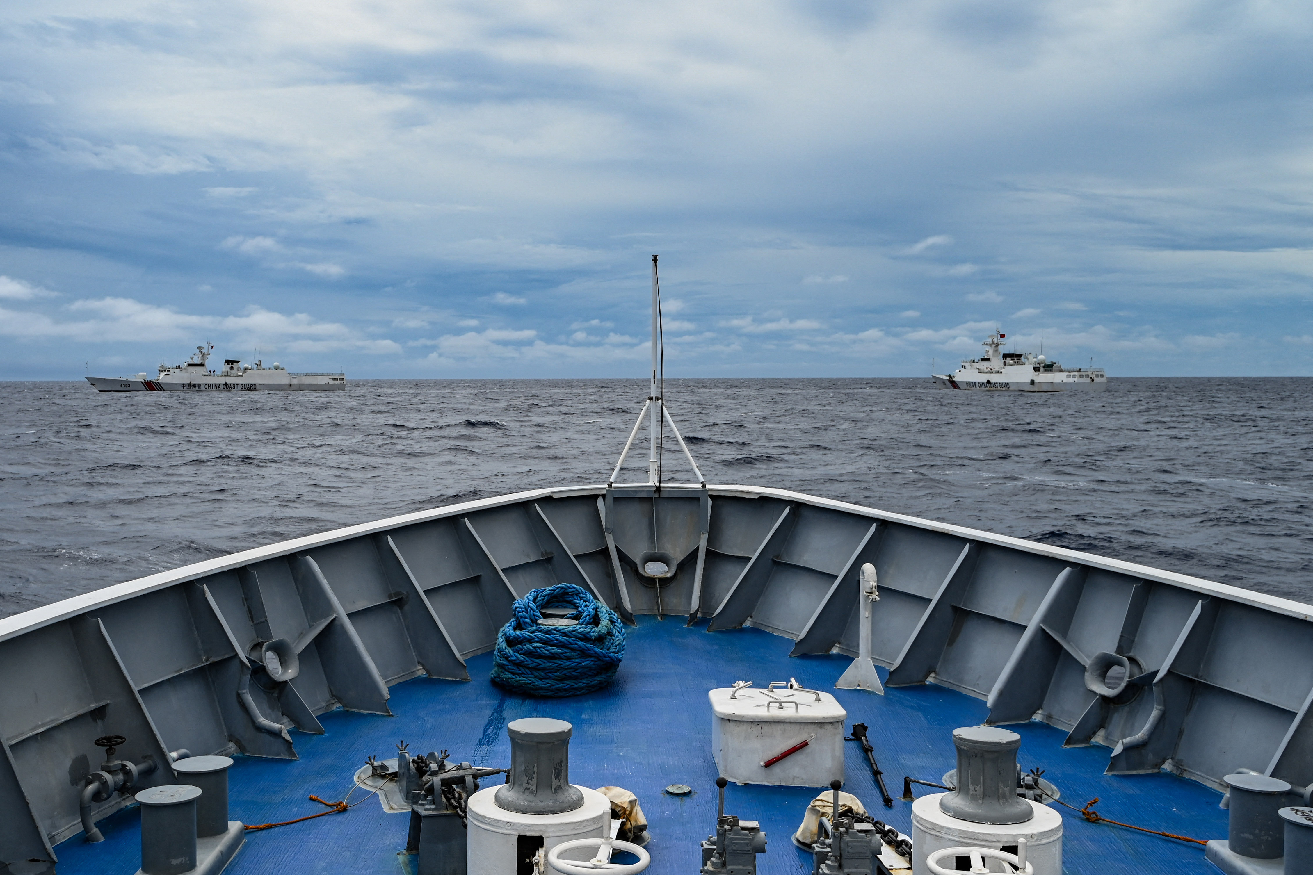 A view of Chinese coast guard ships seen from the bow of a Philippine coast guard vessel