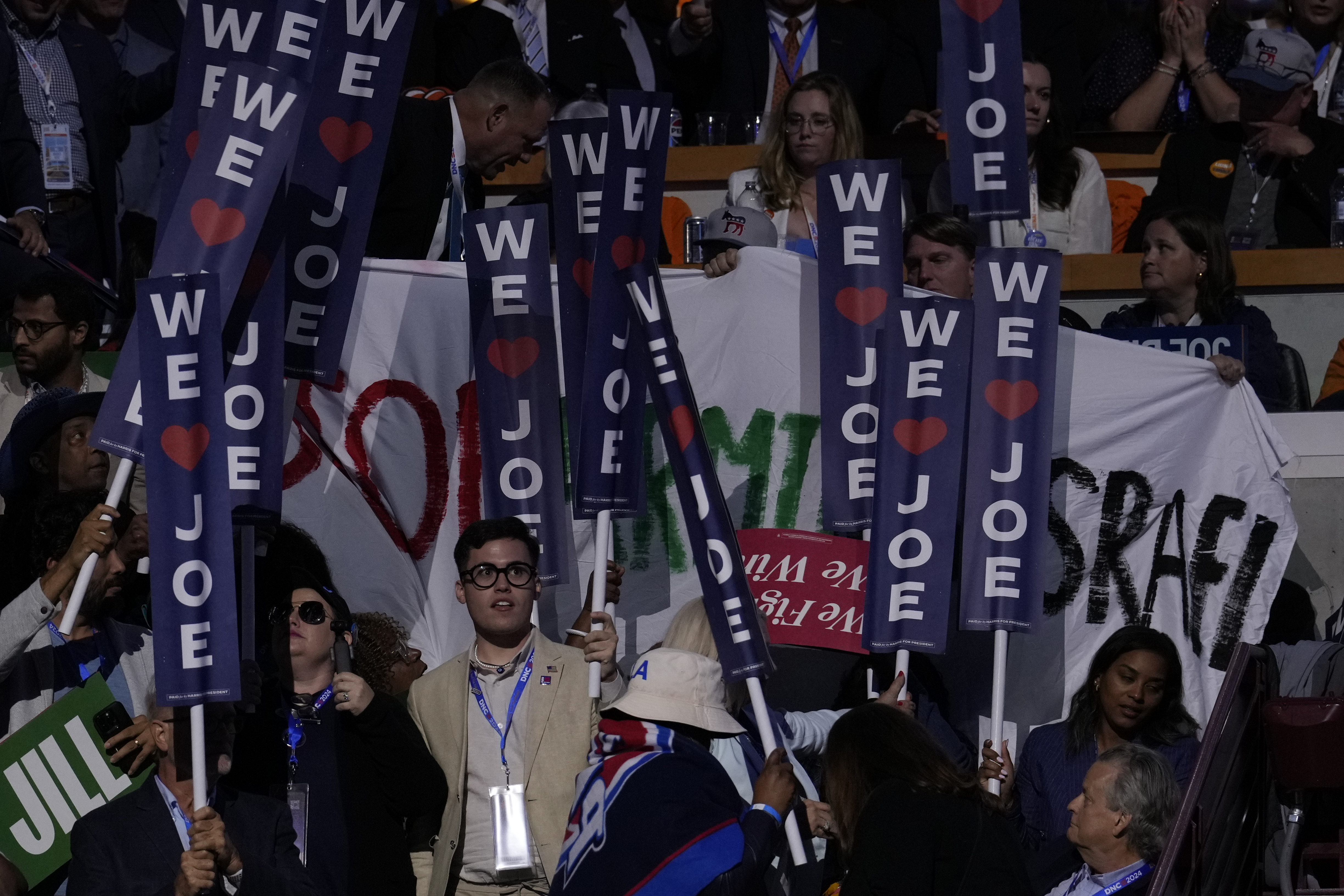A protest banner is partially blocked during President Joe Biden's remarks at the Democratic National Convention on Monday, Aug. 19, 2024, in Chicago. (AP Photo/J. Scott Applewhite)