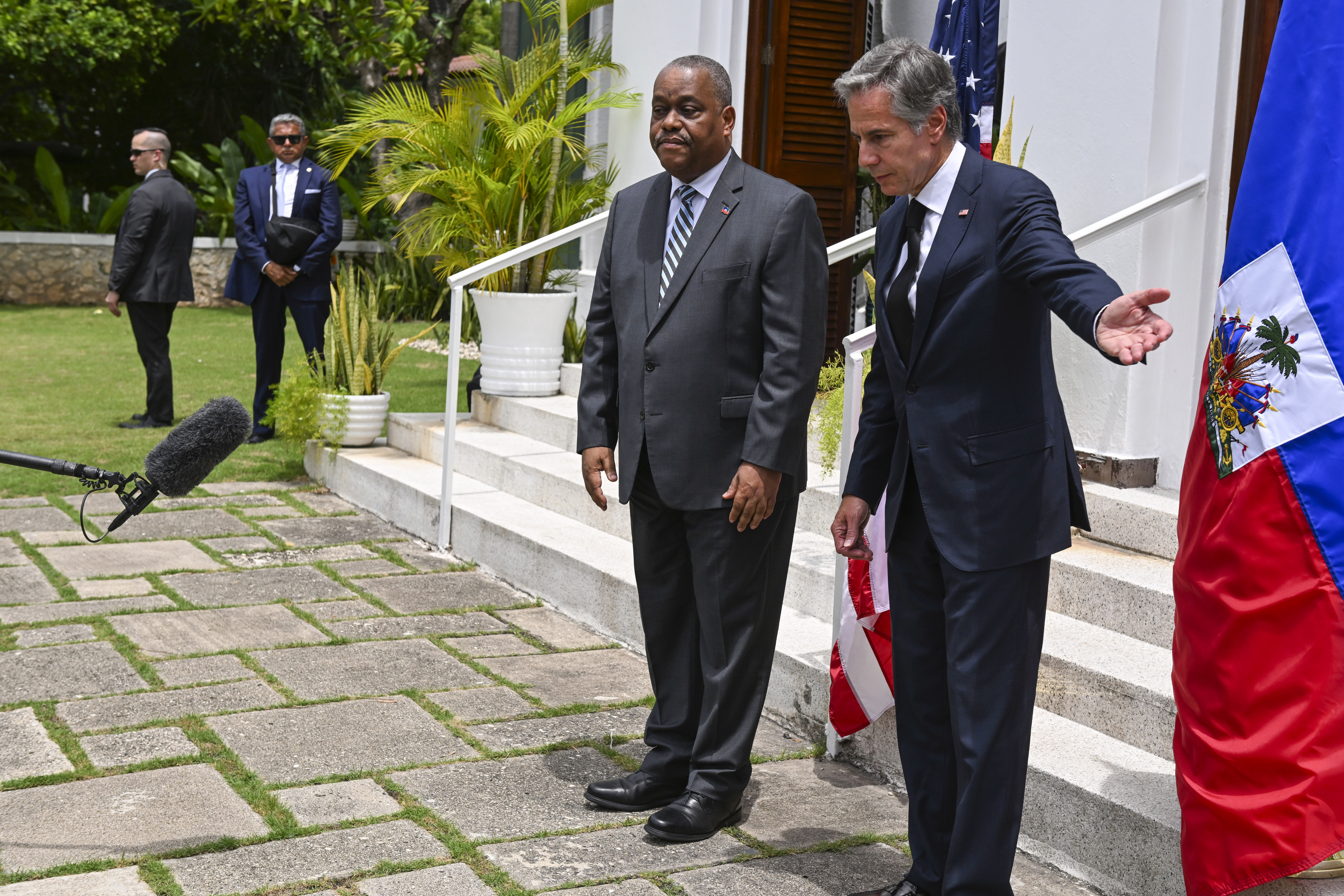 Gary Conille and Antony Blinken speak on the steps of the US Chief of Mission residence in Port-au-Prince