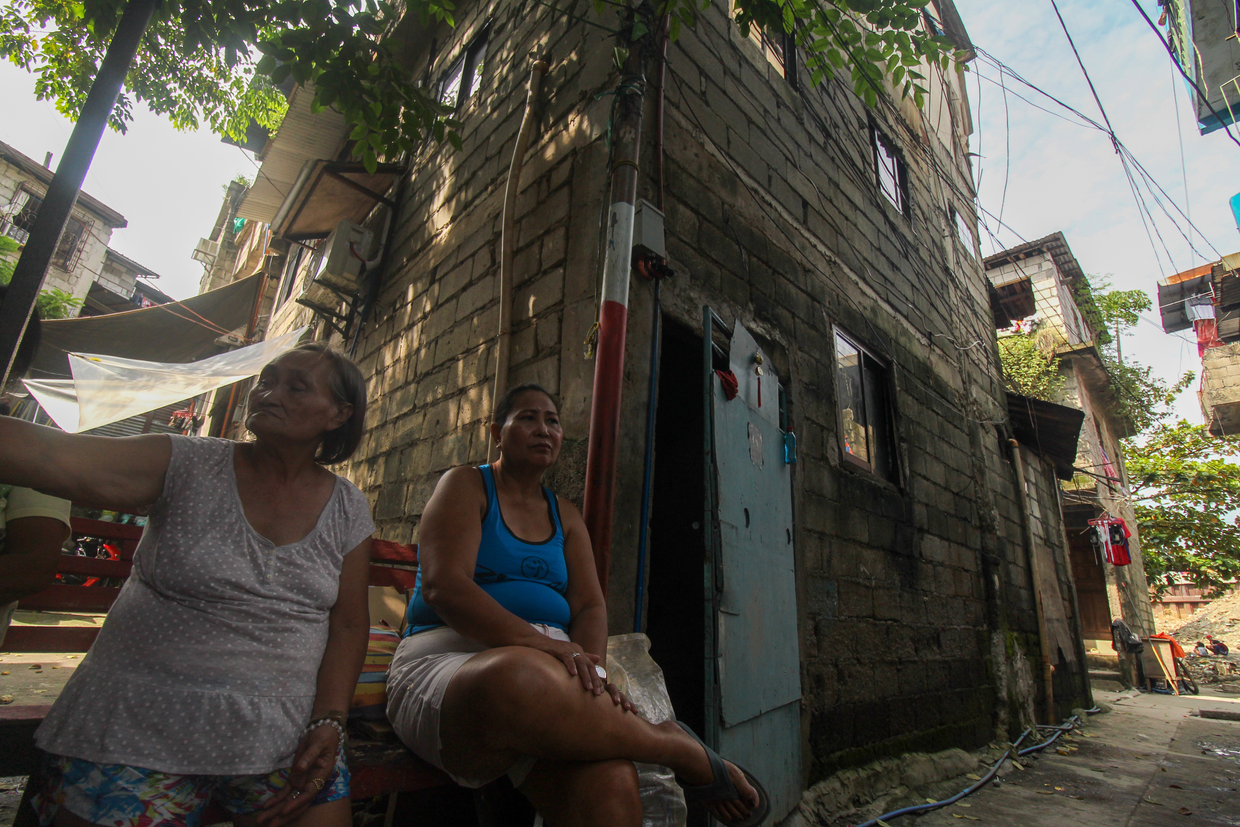 Castillo outside her home The walls on the lower floors of the three storey home are darker because of flooding