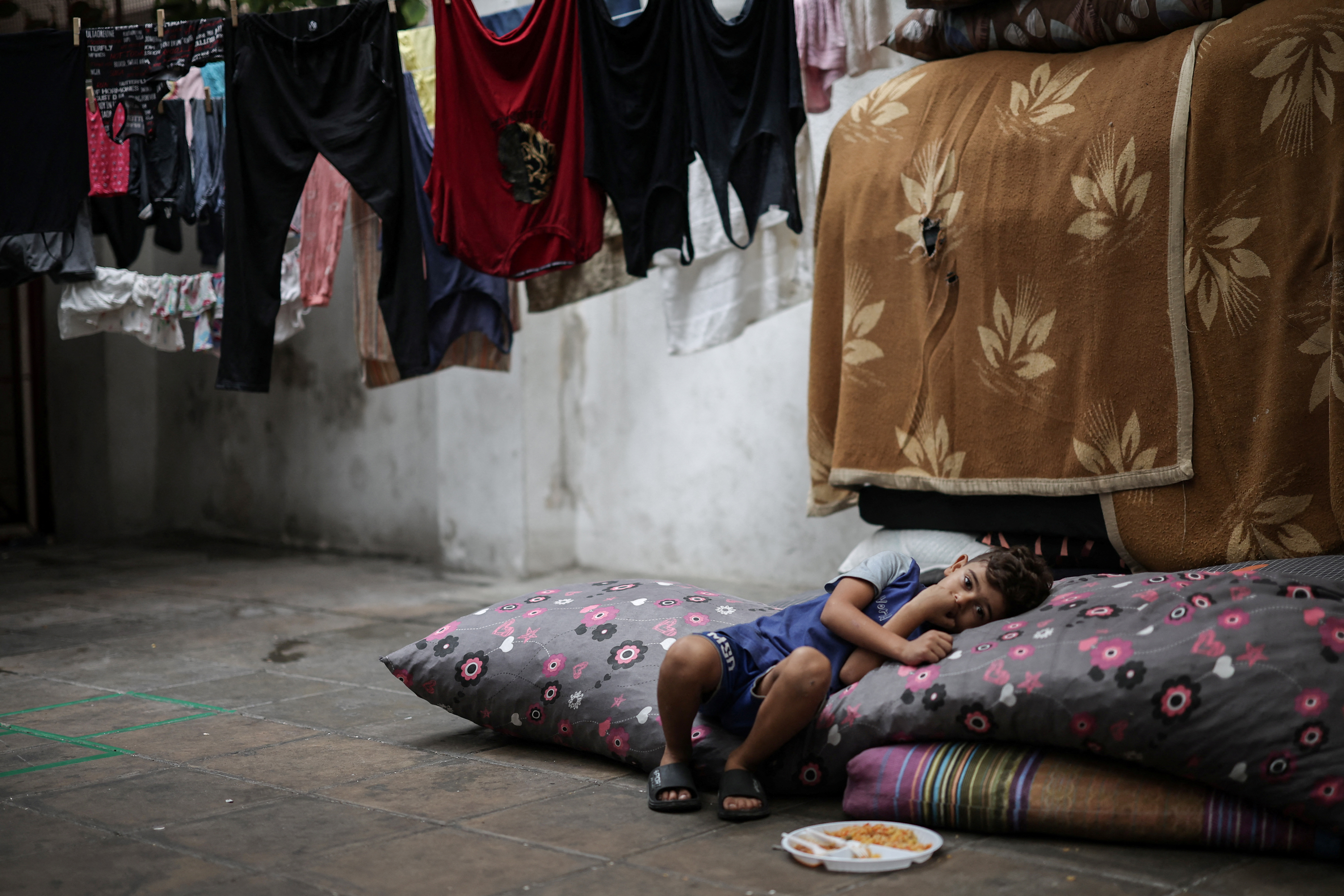 Displaced boy rests in a school which provides temporary shelter to the families, amid the ongoing hostilities between Hezbollah and Israel