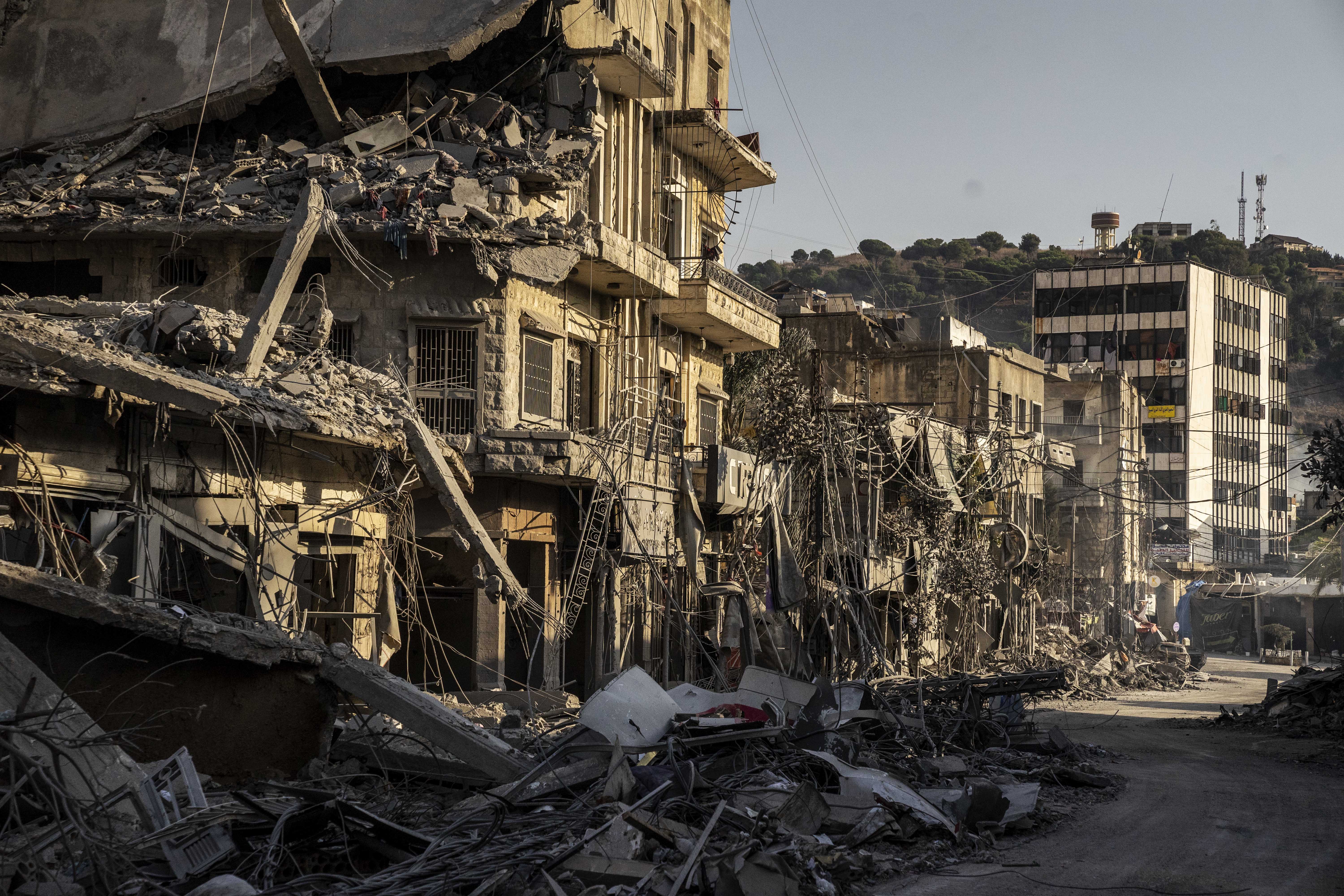 NABATIEH, LEBANON - OCTOBER 16: A view of damage as civil defense teams, along with local residents, mobilize to assist in the recovery efforts, working to clear the wreckage of the destroyed buildings and provide aid to those affected aftermath of Israeli attack on Nabatiah, Lebanon on October 16, 2024. After a six-day pause, the Israeli attacks resume to target Beirut, the capital of Lebanon. The latest airstrikes, particularly severe in the southern city of Nabatiyeh, reportedly resulted in numerous fatalities and injuries. The aftermath revealed significant destruction, with debris scattered throughout the area. ( Jose Colon - Anadolu Agency )