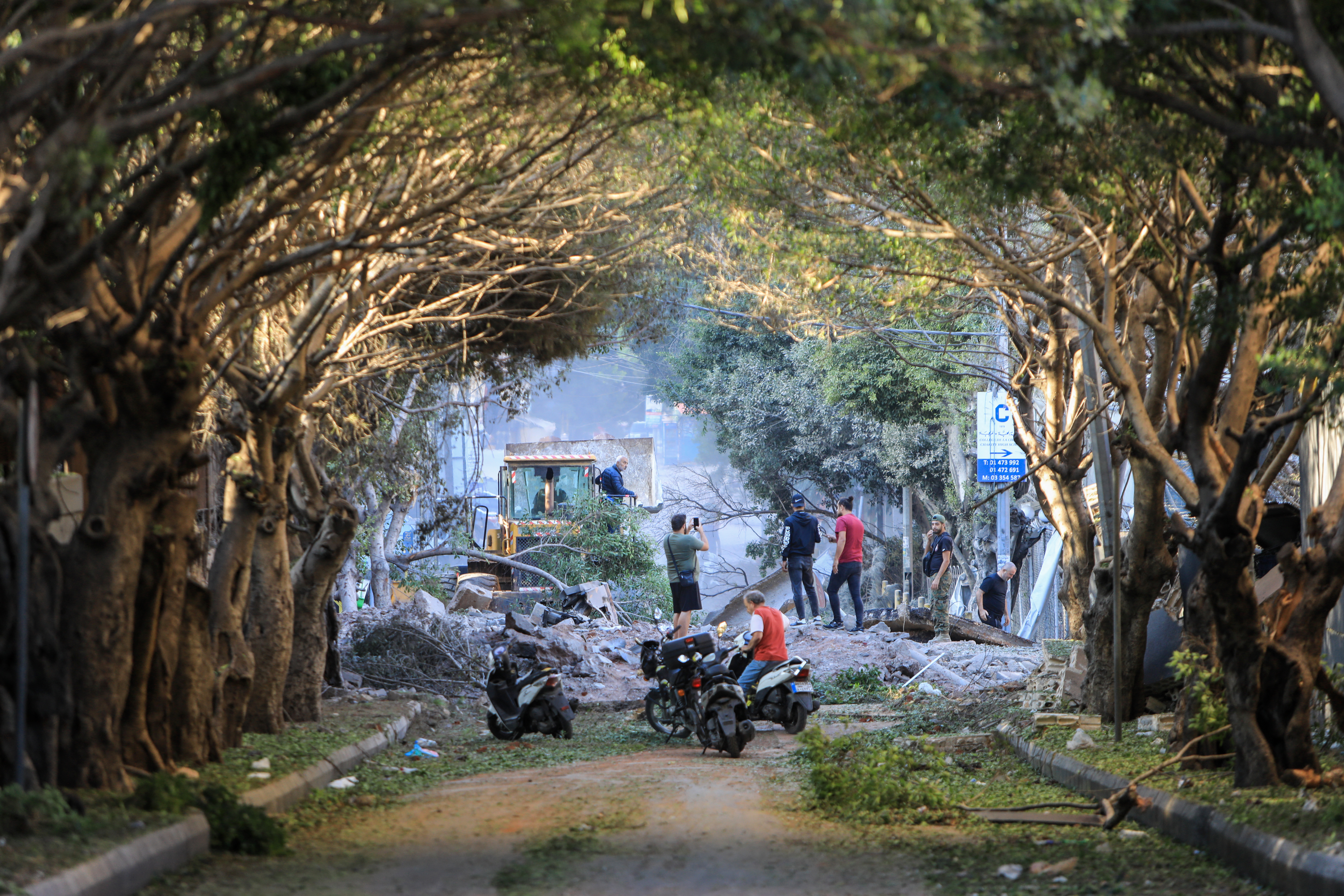 Residents inspect the destruction follwing Israeli airstrikes on the Mreijeh neighbourhood in Beirut's southern suburbs on October 4