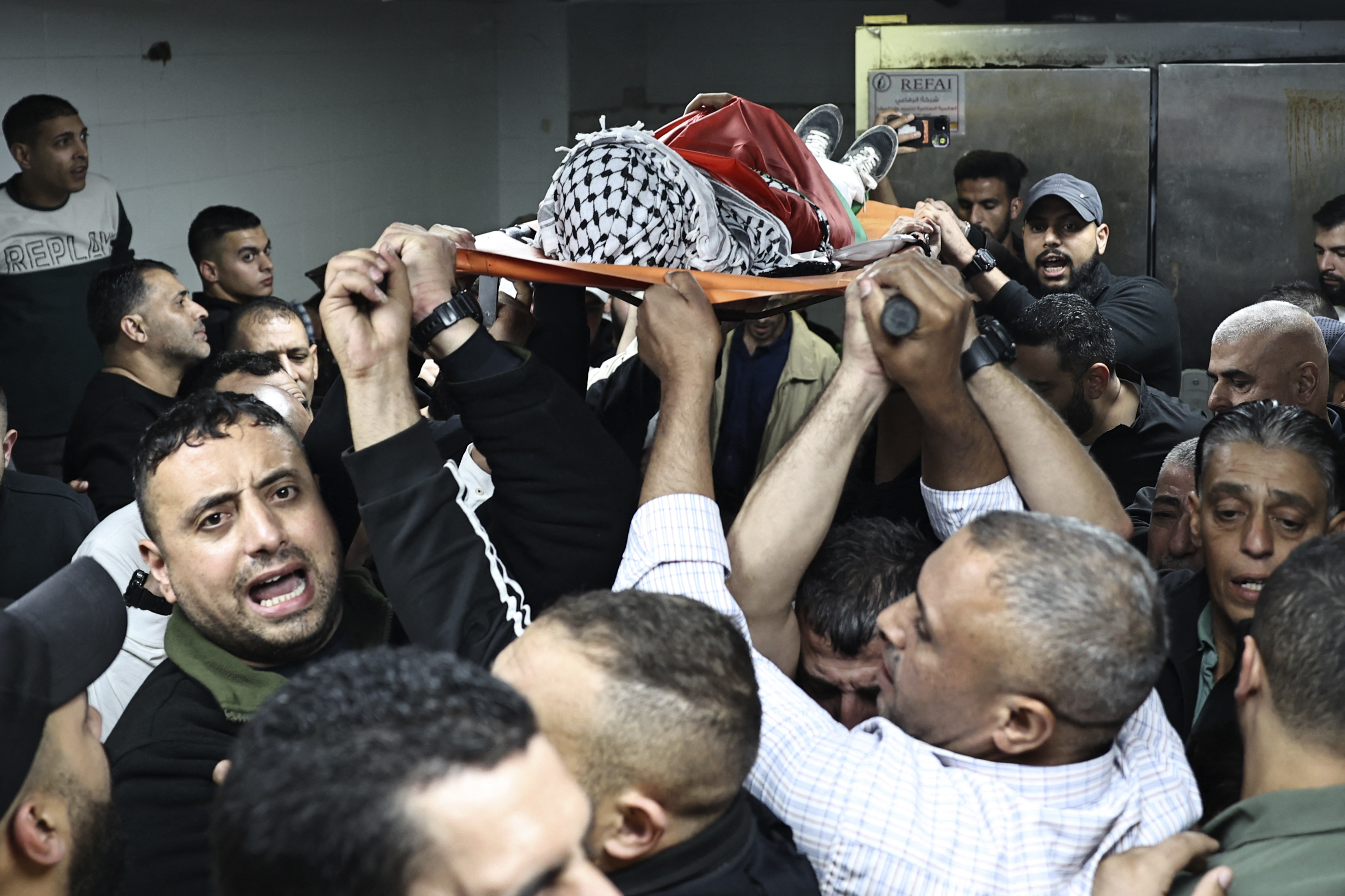 Mourners carry the body of 11-year-old Abdallah Hawash