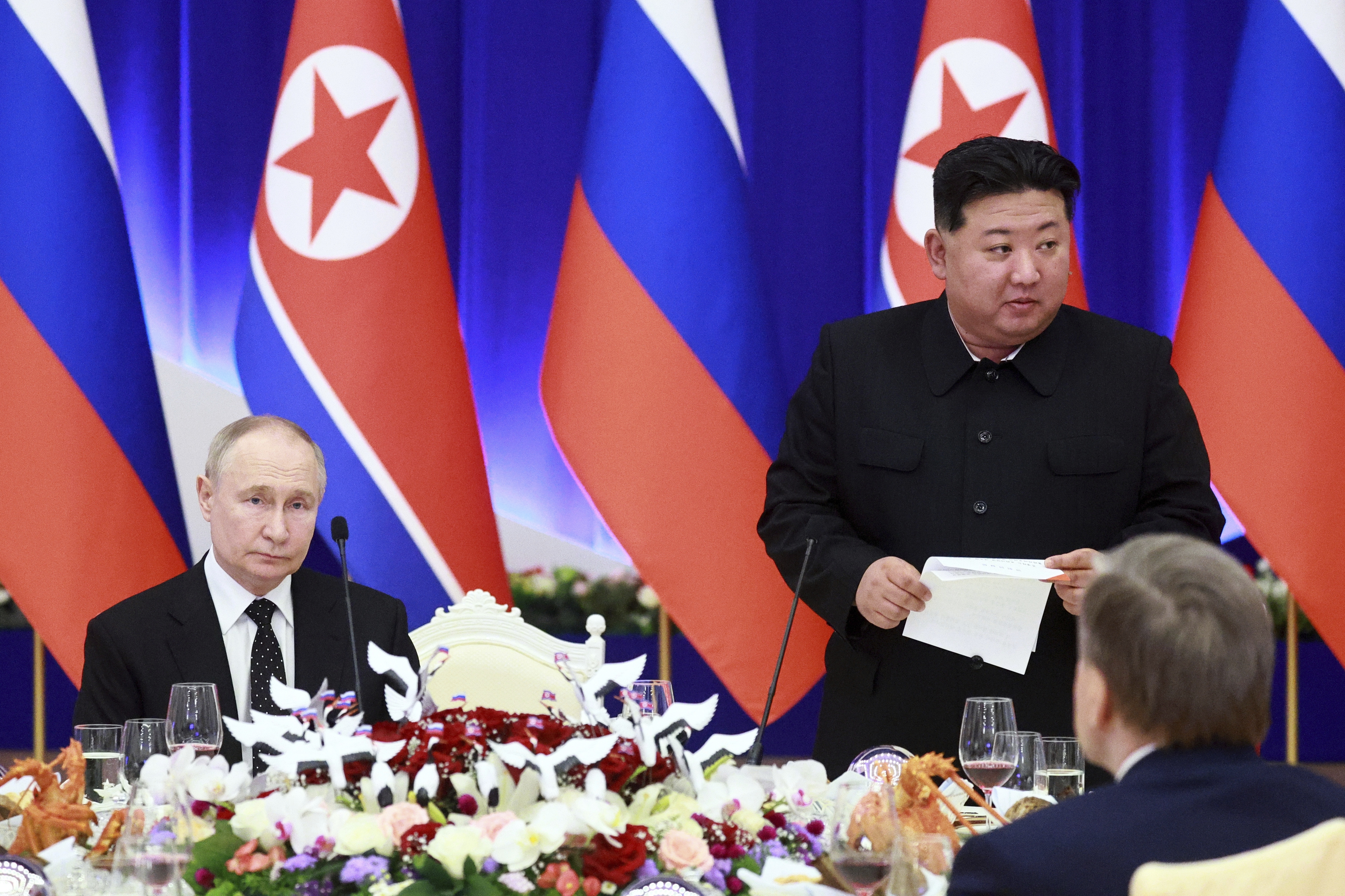 Russian President Vladimir Putin, left, and North Korea's leader Kim Jong Un attend a State Reception after their talks in Pyongyang, North Korea, on Wednesday, June 19, 2024.