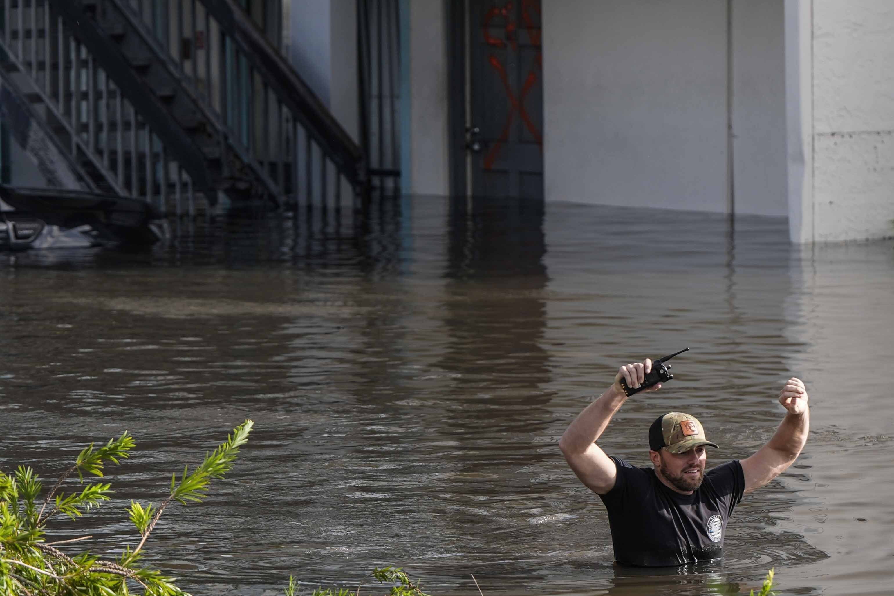 A water rescue team member walks through flood waters at an apartment complex in the aftermath of Hurricane Milton, Thursday, Oct. 10