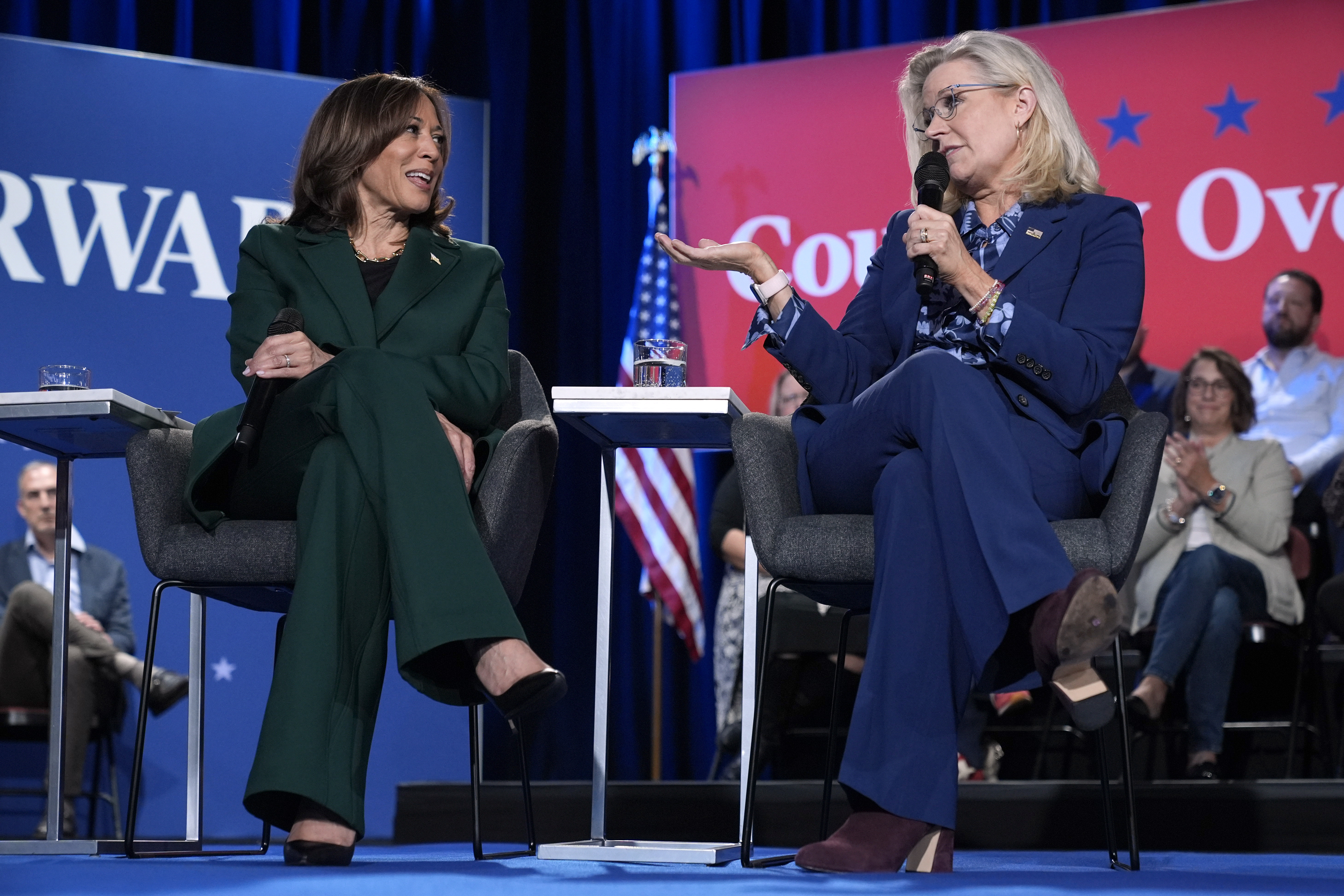 Former Republican Congresswoman Liz Cheney speaks as Democratic presidential nominee Vice President Kamala Harris listens