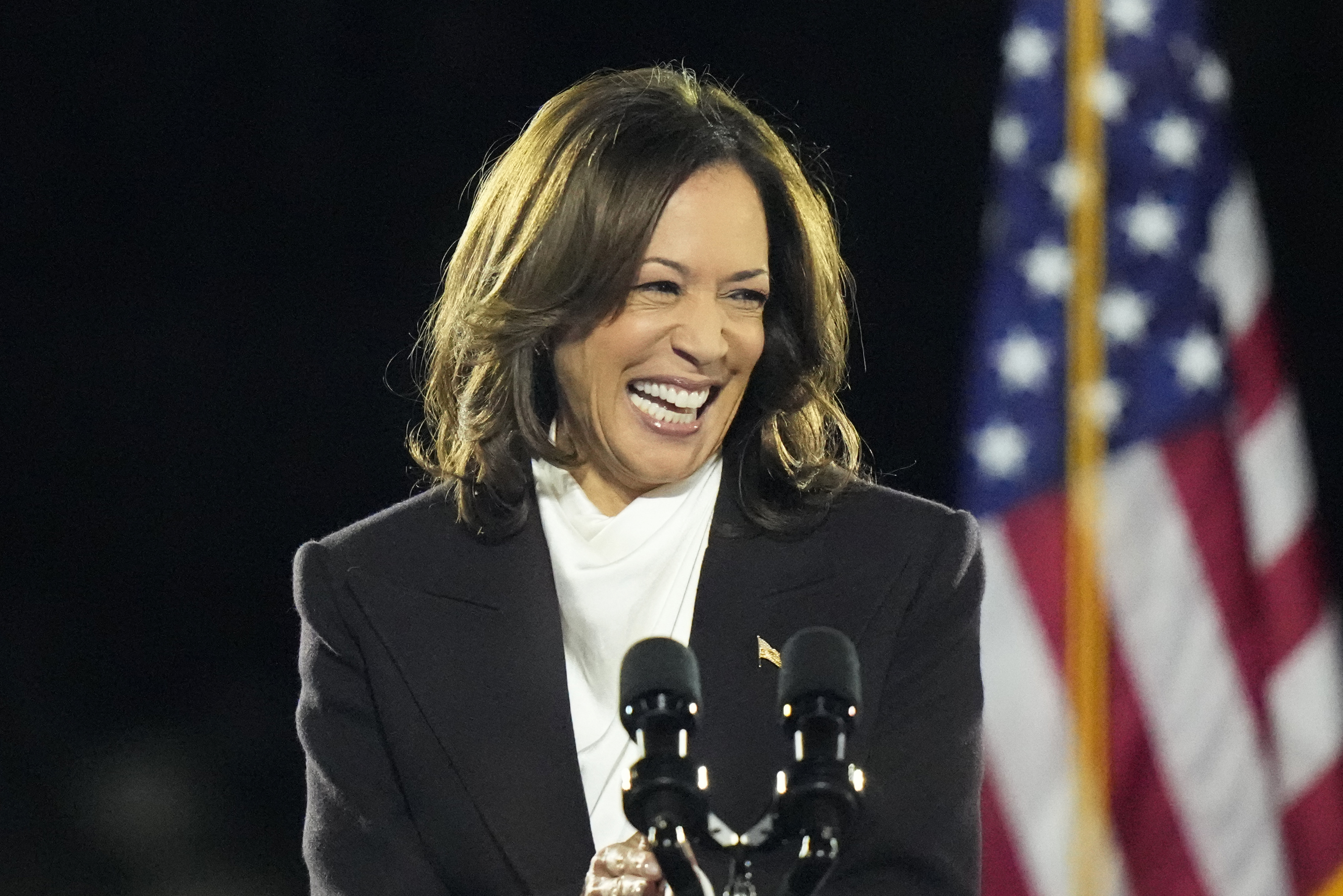 Kamala Harris speaks at a podium in Washington, DC, in front of a US flag.
