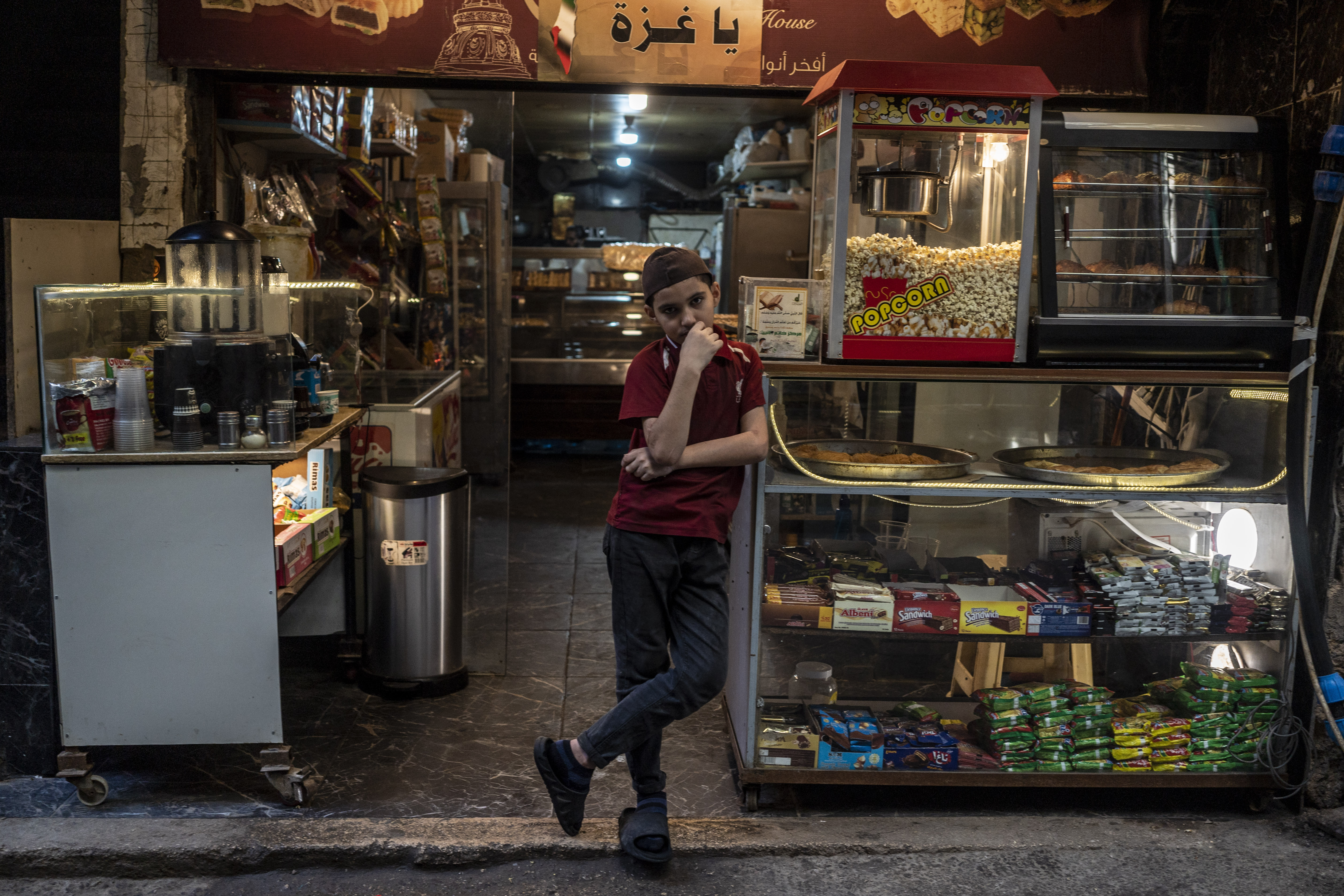 A child stands in front of store at the Palestinian refugee camp of Burl al Barajneh in Beirut, Lebanon on October 26, 2023. Camp was built in 1948, in the aftermath of the 'Nakba', a period during which Palestinians were compelled to leave their homes and villages. It was established on a one-square-kilometer piece of land with the intention of accommodating 10,000 refugees. Today, Burj al Barajneh is the residence of approximately 31,000 refugees, including a significant number who have sought shelter there after escaping the conflict in Syria.