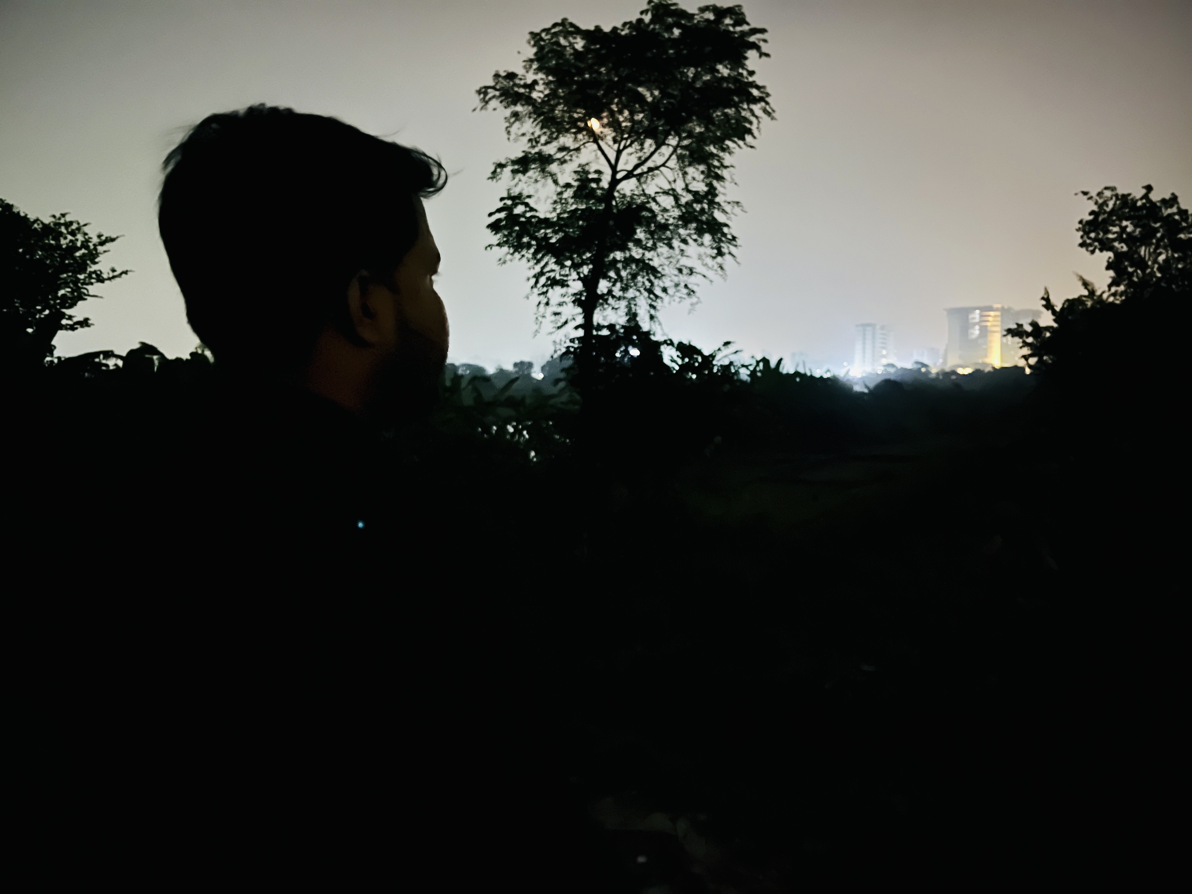 Sujon, a leader of the recently banned Bangladesh Chhatra League, stares into the distance from a spot on the outskirts of Dhaka. Sujon is in hiding since the ouster of Prime Minister Sheikh Hasina. The BCL is the student wing of Hasina's party [Mehedi Hasan Marof/Al Jazeera]