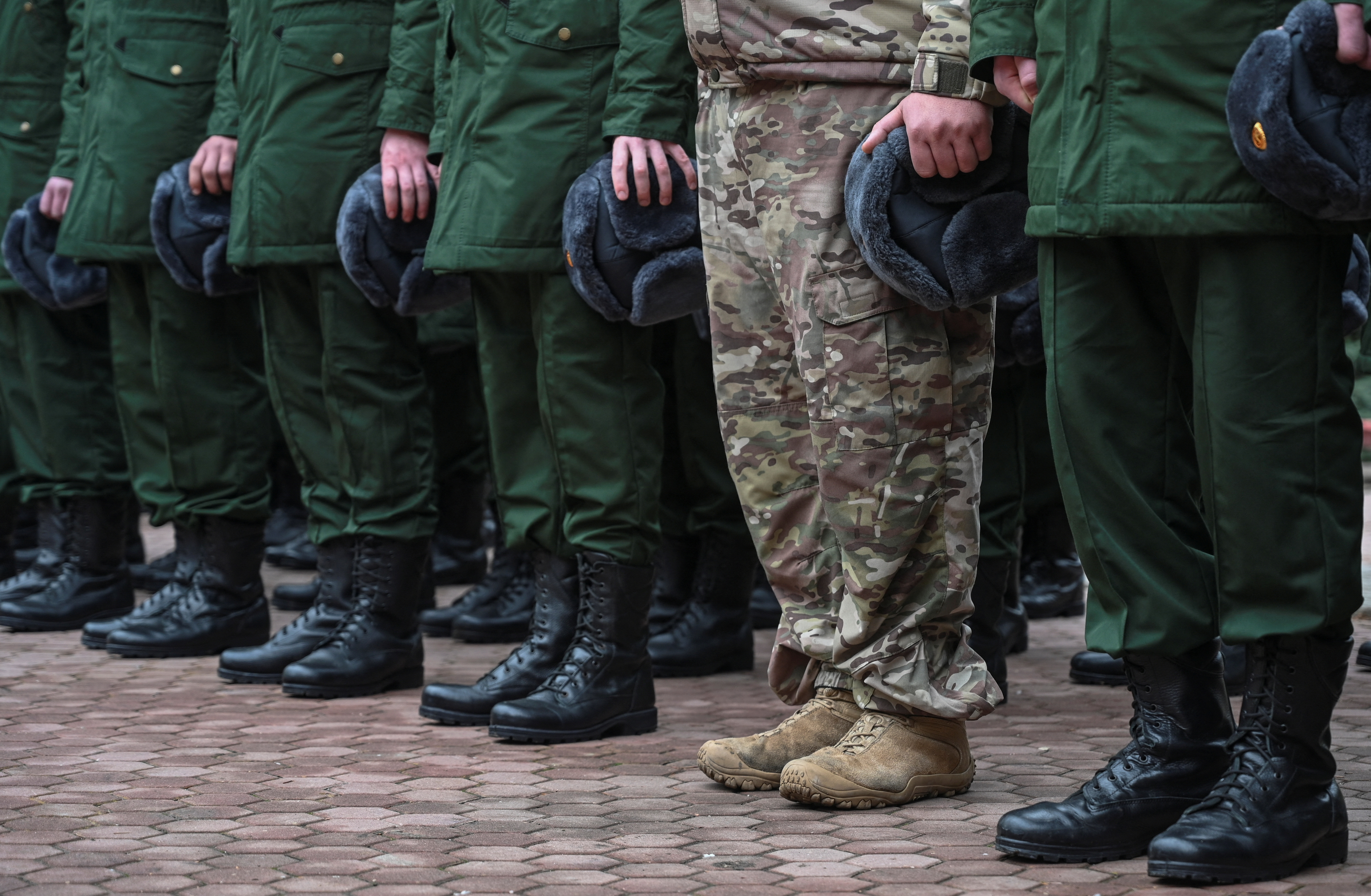 Russian conscripts called up for military service line up before their departure for garrisons in Bataysk in the Rostov region of Russia on October 20, 2024. The UK says its new sanctions will hamper Russia's military capabilities [Sergey Pivovarov/Reuters]