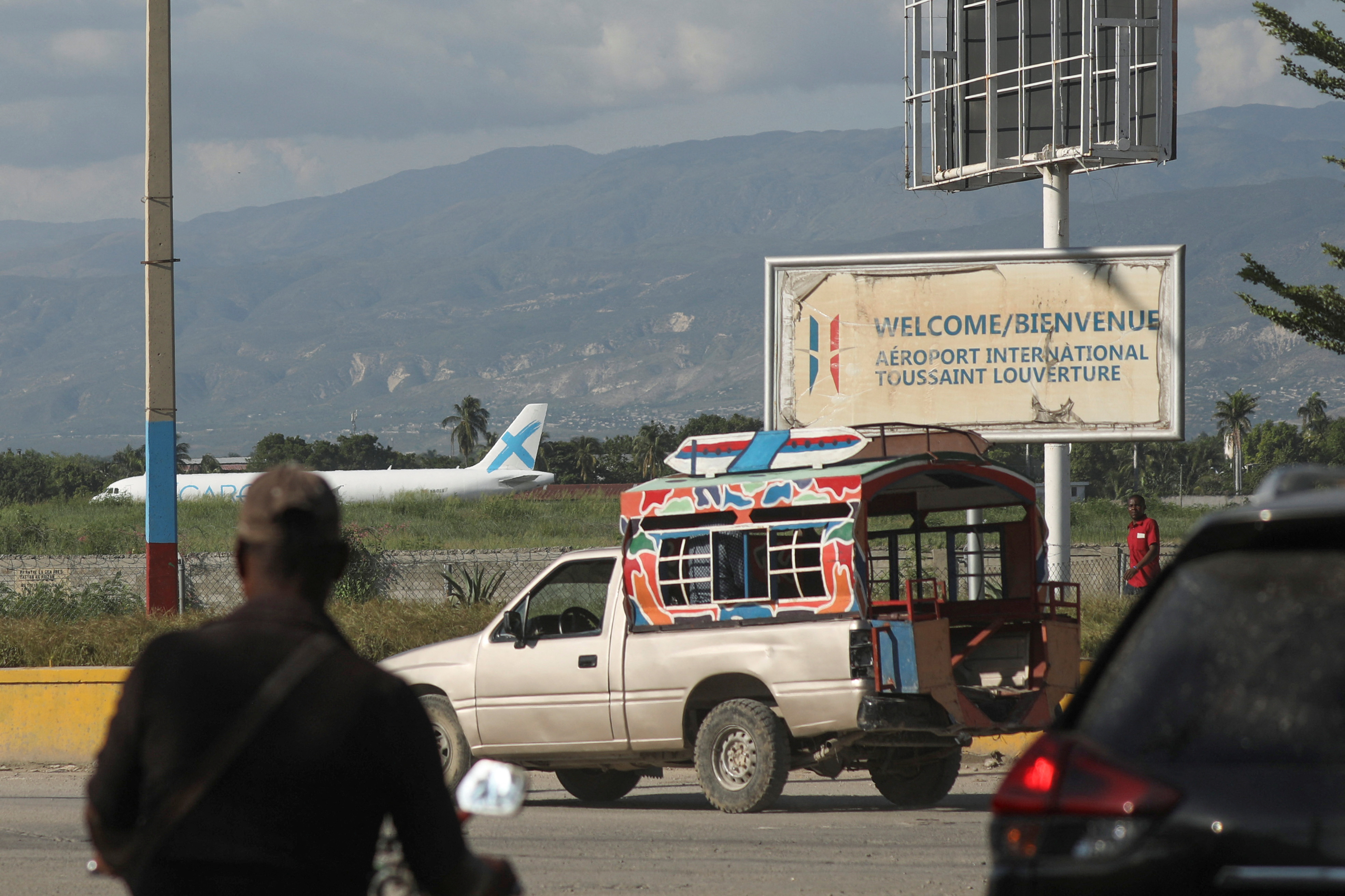 A person walks outside Toussaint Louverture International Airport after airlines suspended flights, in Port-au-Prince, Haiti October 25, 2024. REUTERS/Ralph Tedy Erol