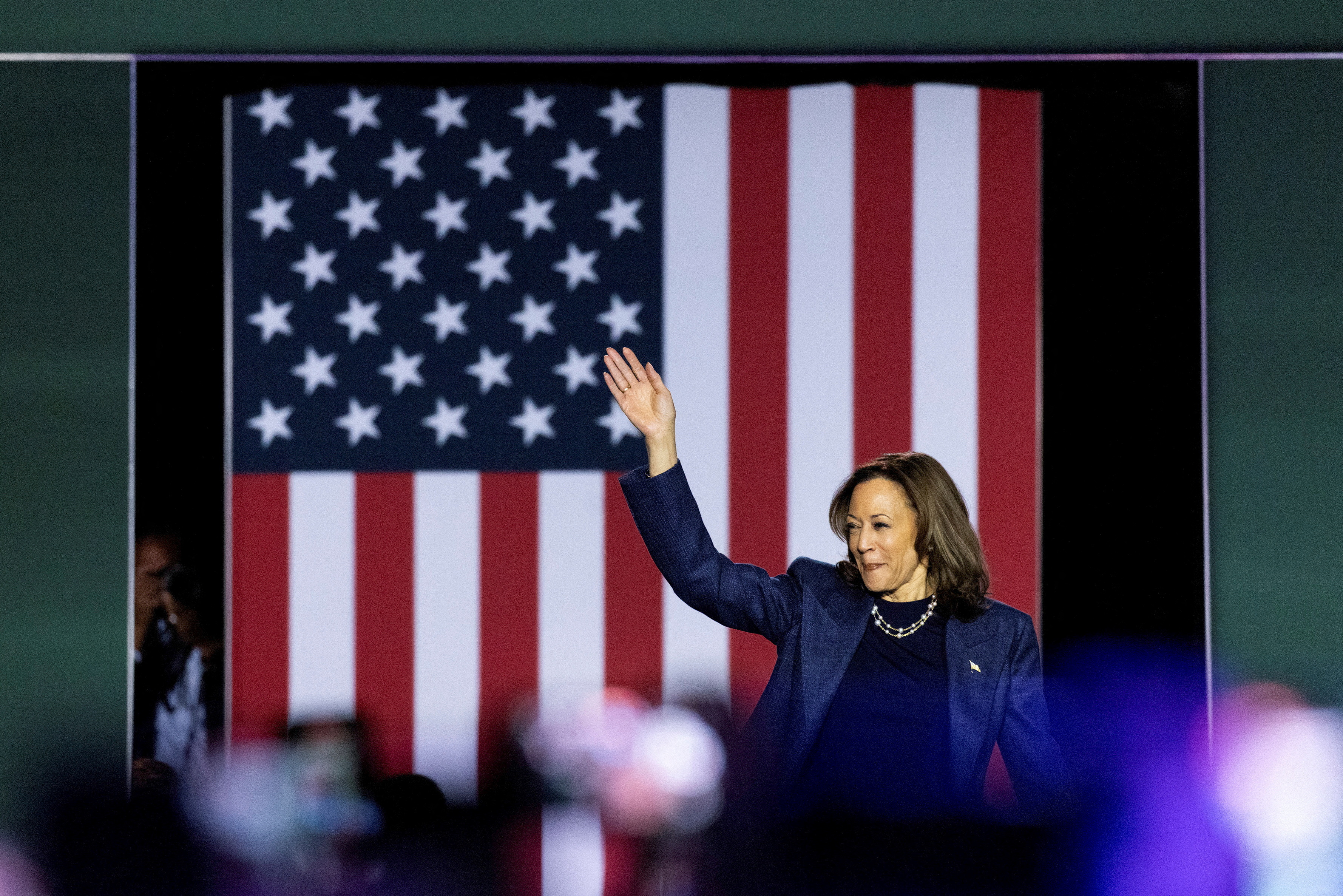 US Vice President Kamala Harris waves during a campaign rally at Michigan State University