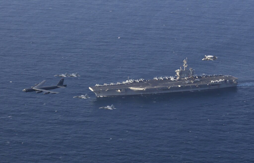 FILE - In this June 1, 2019 file photo, the USS Abraham Lincoln carrier and a U.S. Air Force B-52H Stratofortress, conduct joint exercises in the U.S. Central Command area of responsibility in Arabian sea. The Abraham Lincoln that the White House ordered to the Mideast over a perceived threat from Iran remains outside of the Persian Gulf amid efforts to de-escalate tensions between Tehran and Washington. (Mass Communication Specialist 1st Class Brian M. Wilbur/U.S. Navy via AP, File)