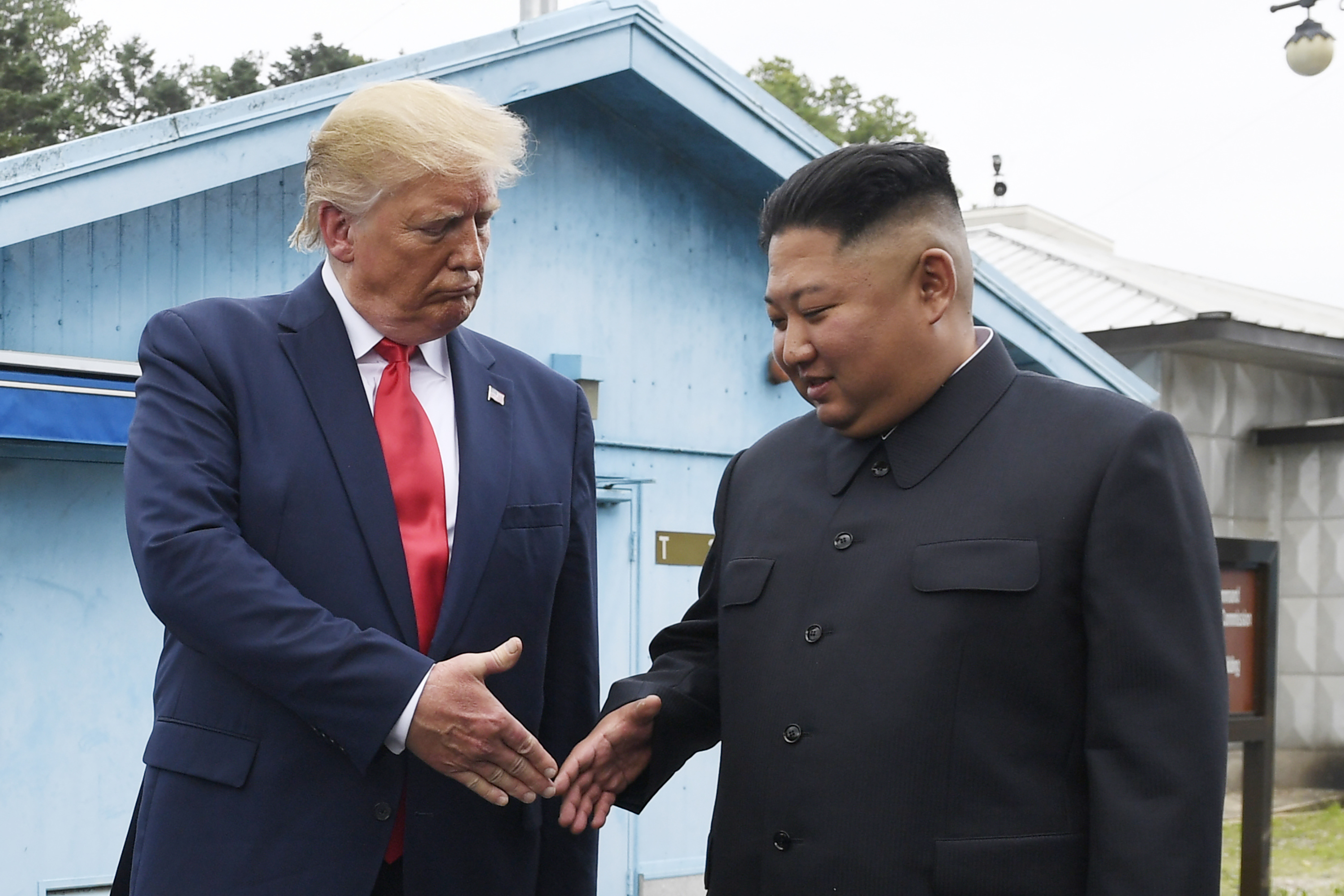 North Korean leader Kim Jong Un, right, and US President Donald Trump prepare to shake hands at the border village of Panmunjom in the Demilitarized Zone, South Korea [File: Susan Walsh/AP]