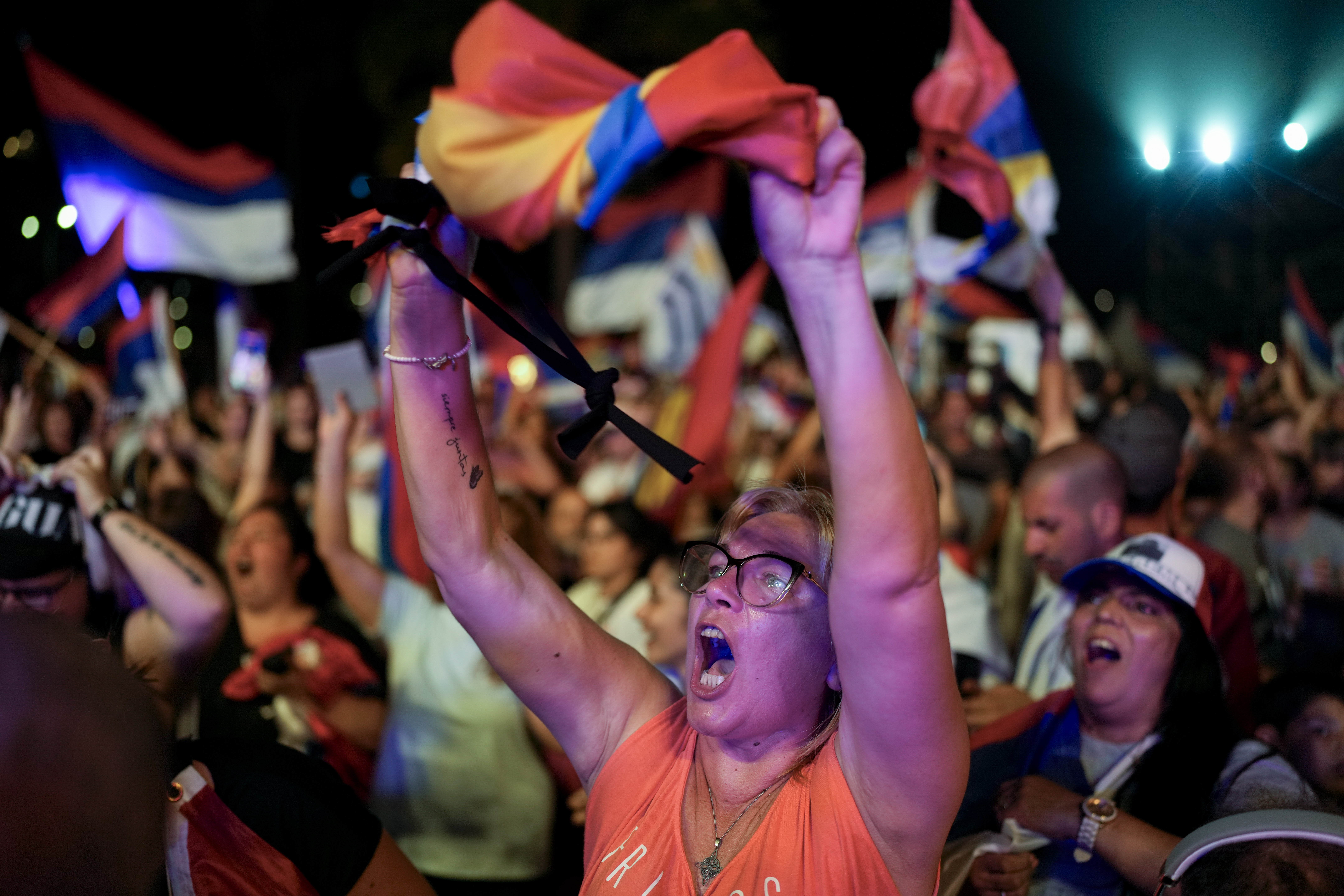 Supporters wave flags in Montevideo as Yamandu Orsi surges ahead in the polls.