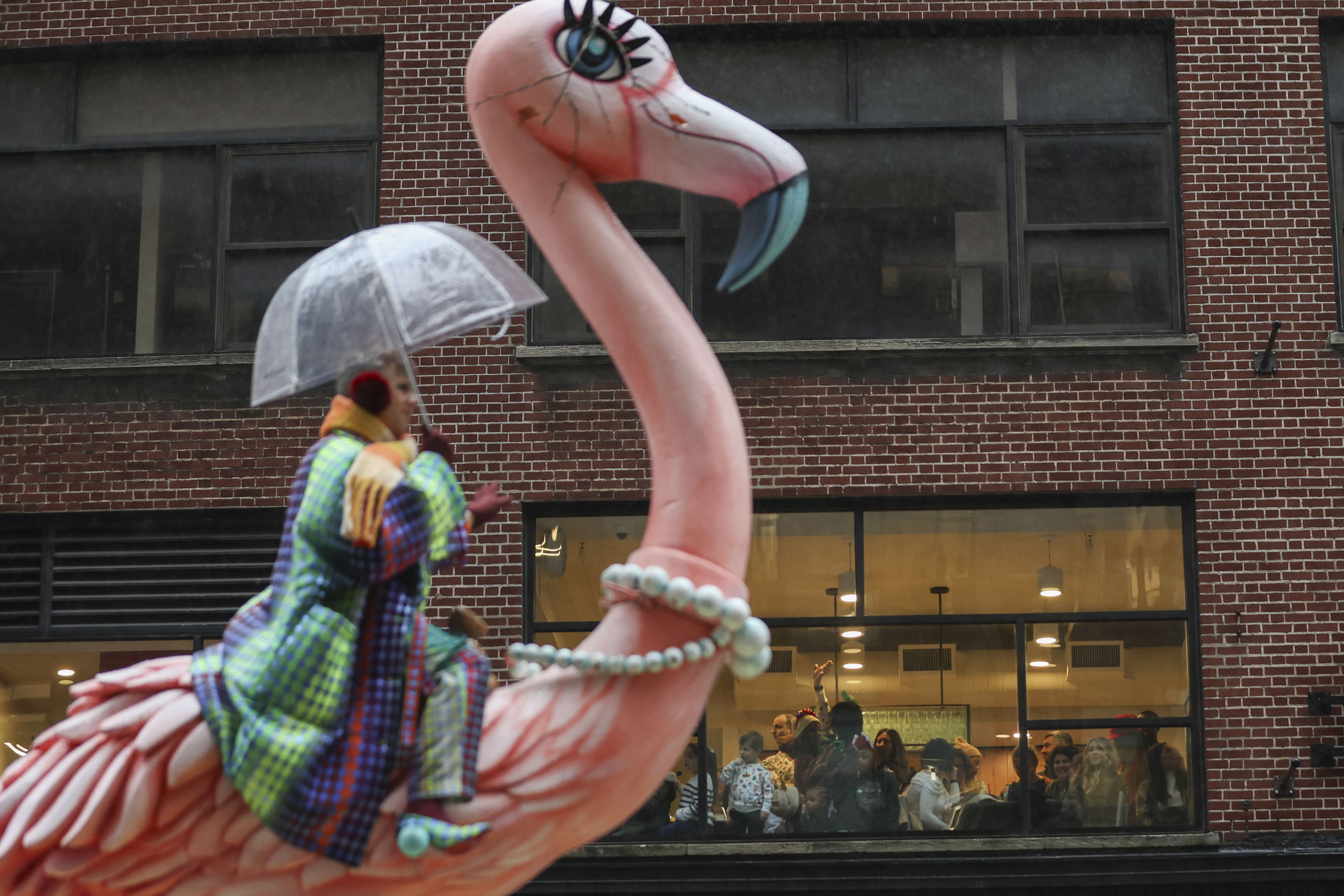 A person rides a flamingo float
