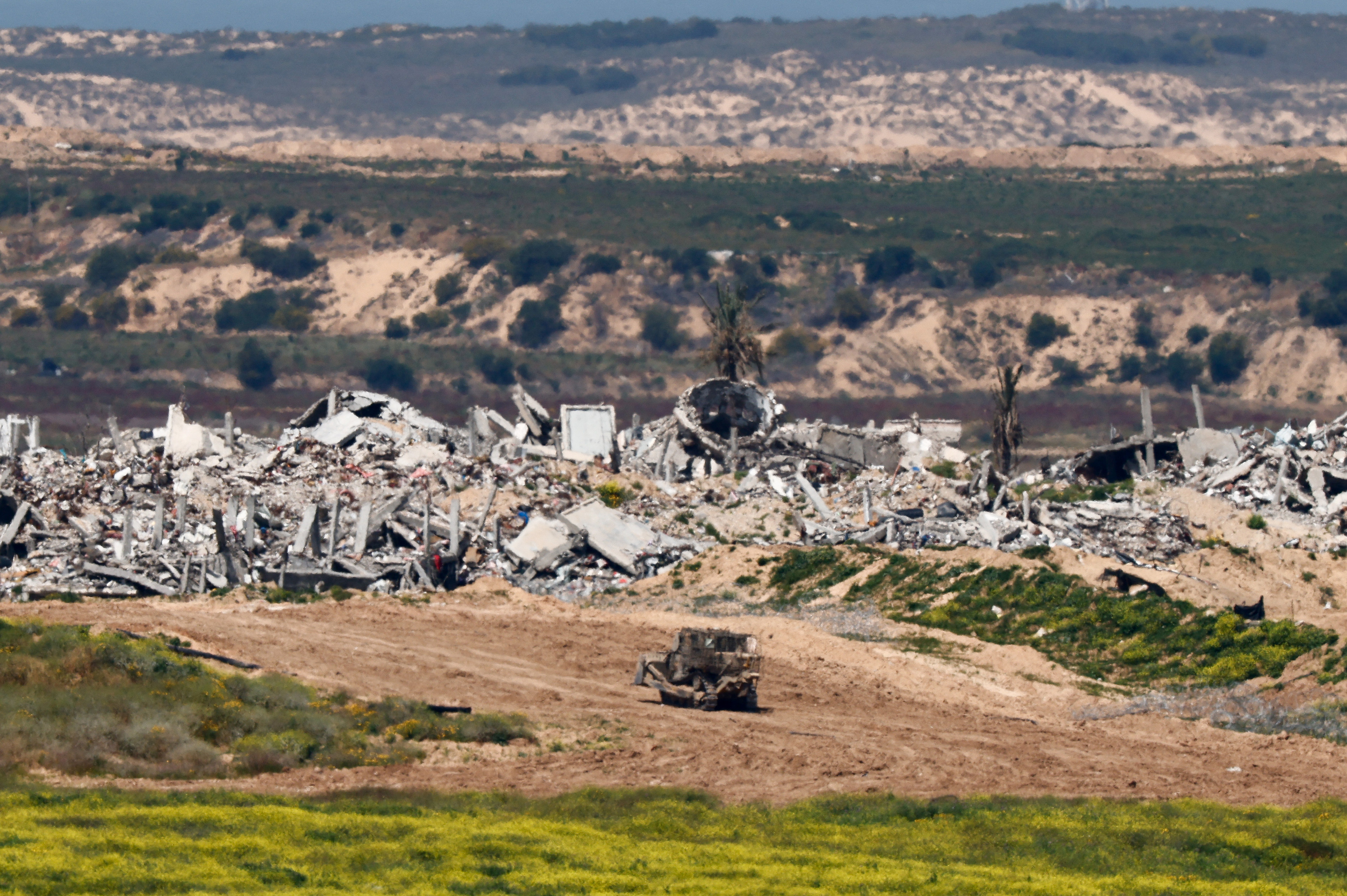 A D9 bulldozer maneuvers inside Gaza Strip, as seen from Israel