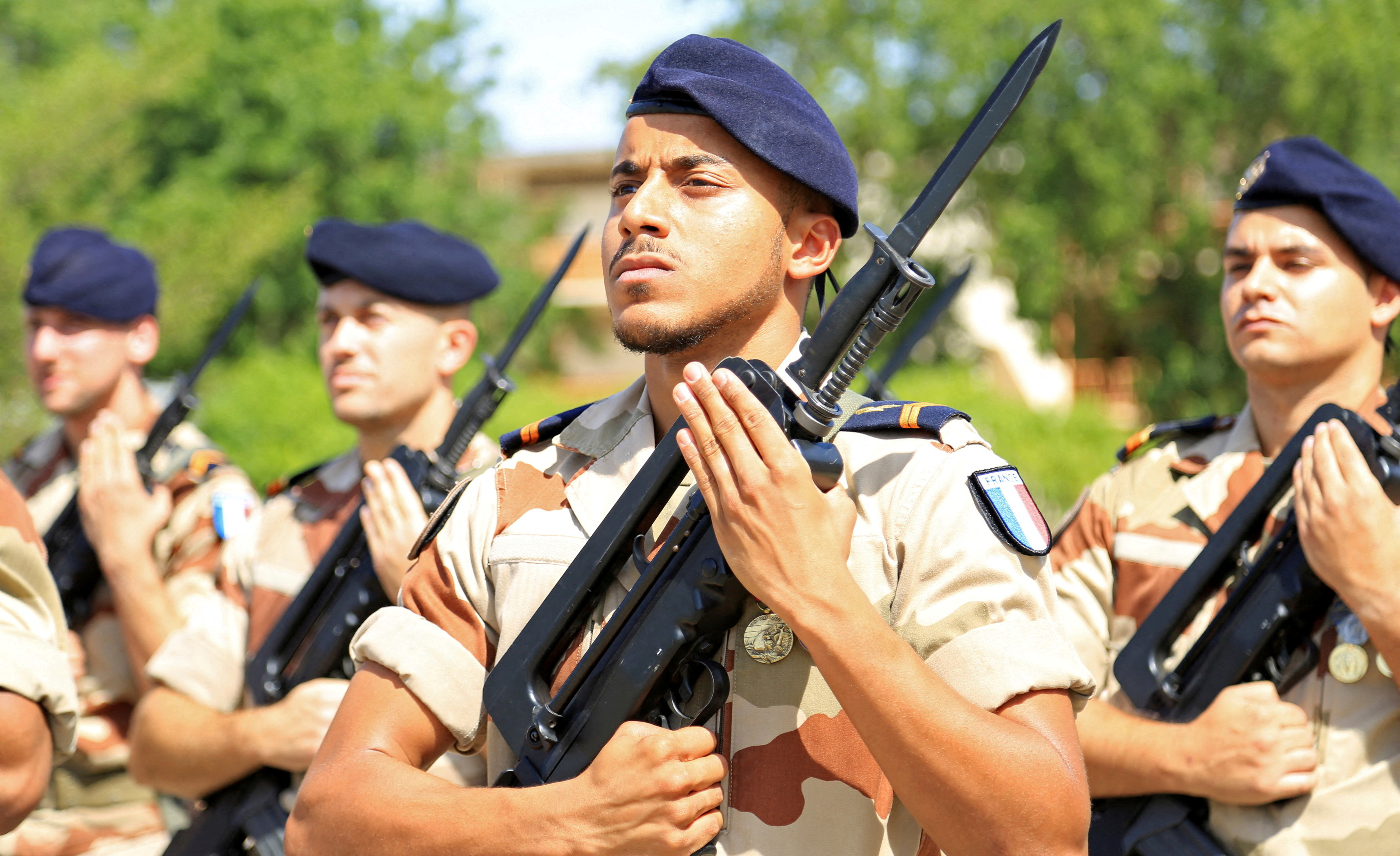 French soldiers stand at attention during a morning drill.