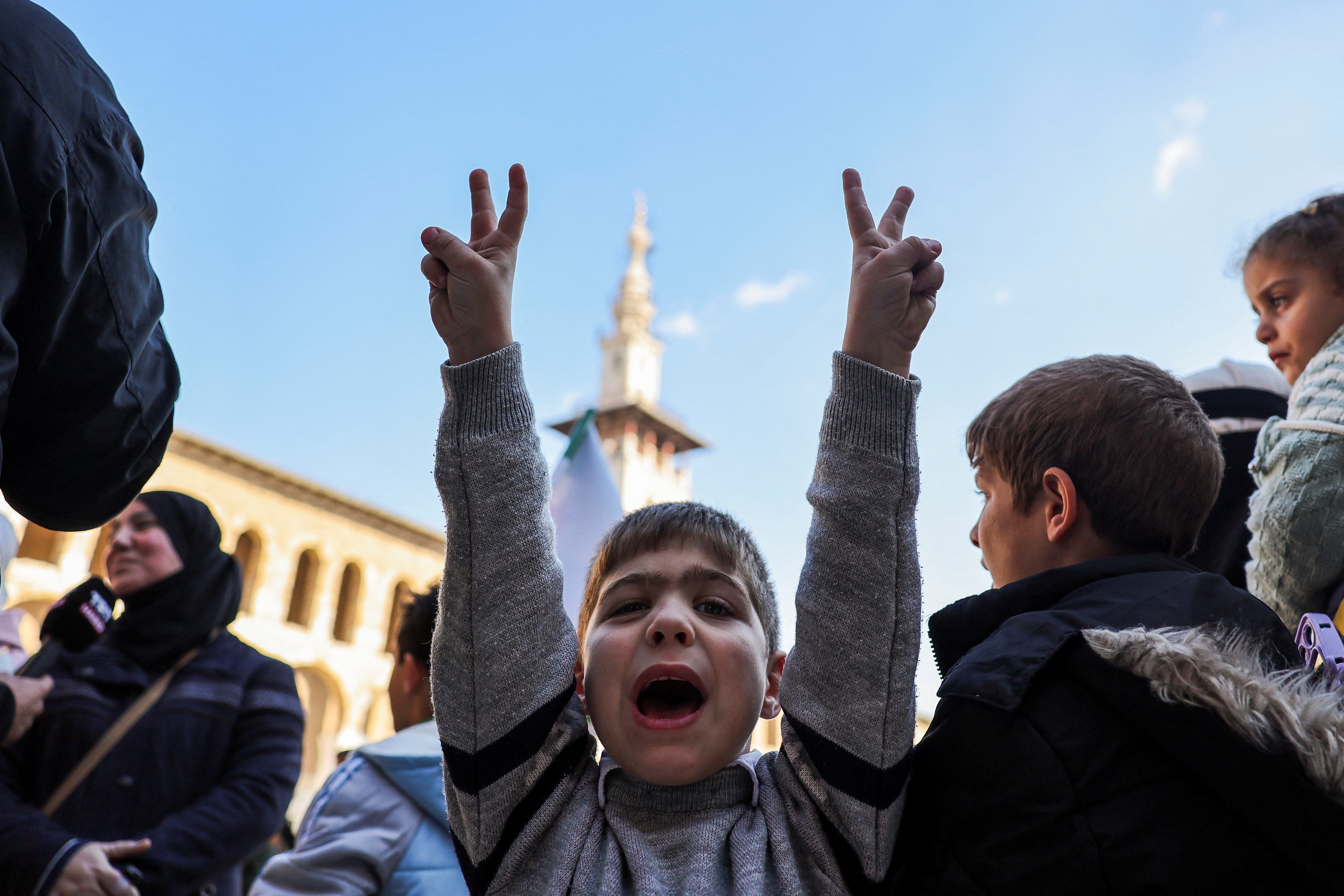 A child gestures at the Umayyad Mosque